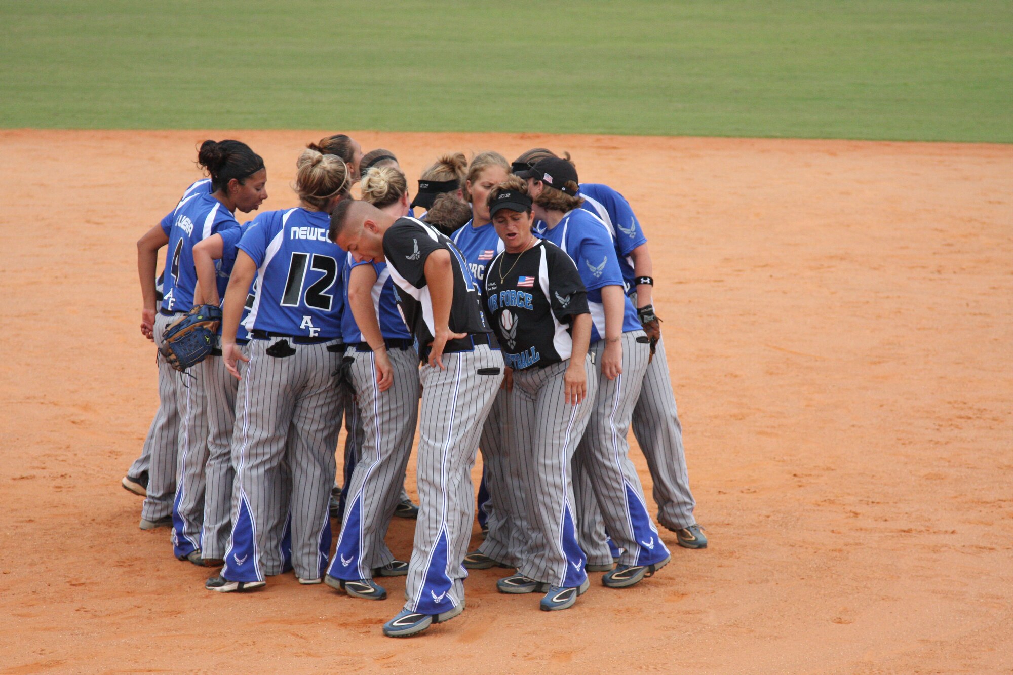 Senior Airman Robert Hofmann and Cheryl Trapnell, coaches for the women's Air Force softball team, lead a cheer after winning the gold medal at the Armed Forces Slow-Pitch Softball Championships. This is the third consecutive year the women's Air Force team has won the top prize.