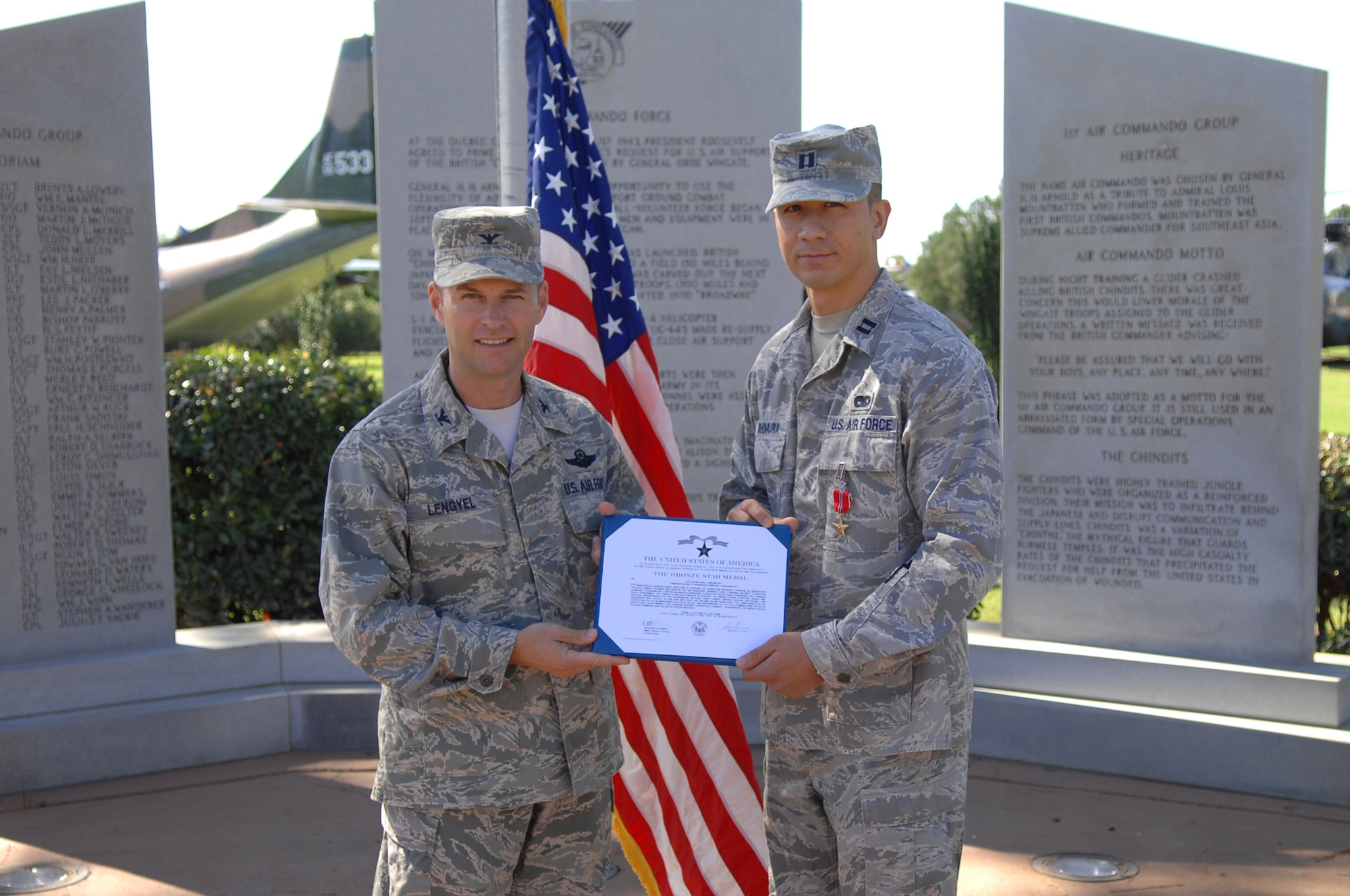 U.S. Air Force Capt. Michael Nishmura of the 1st Special Operations Logistics Readiness Squadron is presented with the certificate accompanying his Bronze Star by Col. Gregory Lengyel, Commander  1st Special Operations Wing, at Hurlburt Field, Sept 30, 2009, Fla. (U.S. Air Force photo by Tech Sgt. Scott MacKay/Released)