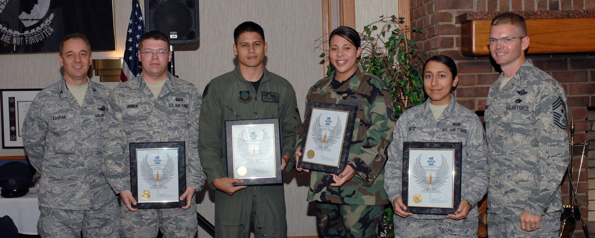 CANNON AIR FORCE BASE, N.M. -- Col.  Ruedi Kaspar (left), 27th Special Operations Wing vice commander, and Command Chief Master Sgt. William Turner (right), 27th Special Operations Wing command chief, stand with this month's Diamond Sharp Award winners. Airman 1st Class William Uriniuk, 27th Special Operations Comptroller Squadron; Airman 1st Class Jacob Peterson, 3rd Special Operations Squadron; Staff Sgt. Stephanie Wilkins, 27th Special Operations Maintenance Squadron; and Airman 1st Class Vivian Ortiz, 16th Special Operations Squadron, received their awards at the Pecos Trail Dining facility Oct 2. The Diamond Sharp Award recognizes Airmen for their outstanding performance in all aspects of their military careers.  (U.S. Air Force photo by Airman 1st Class James Bell)
