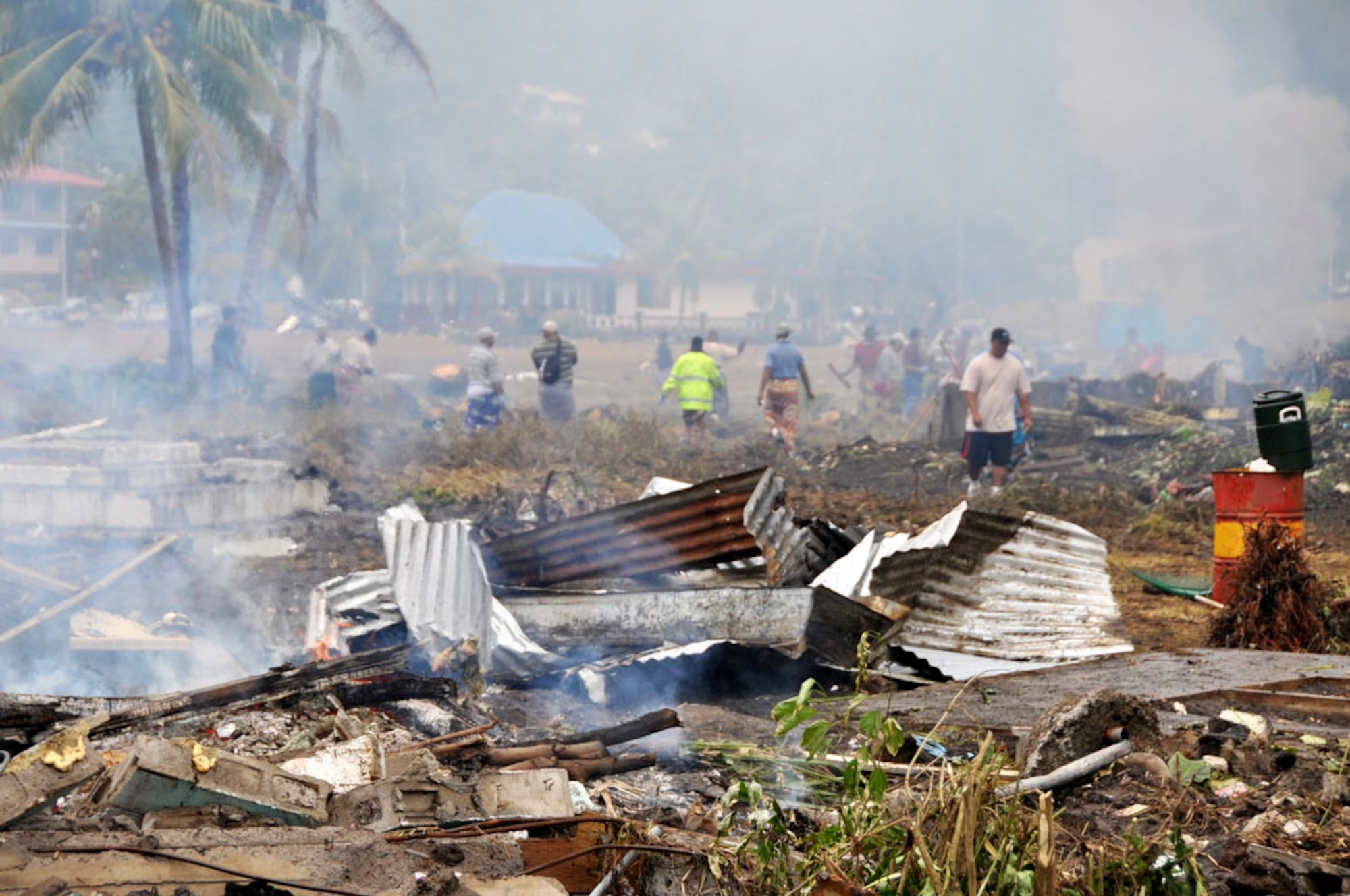 American Samoans pick-up the trash and debris from their homes and businesses Oct. 1, 2009, in Pago Pago, American Samoa. The island nation was struck Sept. 29 by an 8.3 magnitude earthquake generating 15-foot waves and destroying whole villages. (U.S. Air Force photo/Tech. Sgt. Cohen A. Young)