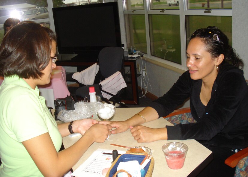 (Left to right)  Tech. Sgt. Brooke Matthews, 96th Force Support Squadron, gives Maureeca Wells a manicure as part of the Hearts Apart Spa Day Sept. 19.  Mrs. Wells' spouse is Tech. Sgt. James Wells, 9th Special Operations Squadron, who is deployed to Iraq.   The 'spa day' had professional massages, facial massages and cosmetics.  Volunteers manicured nails and provided hand massages. Several local spas donated gift certificates as well.  The Hearts Apart program helps provide outreach and services to military, Department of Defense civilians and family members who are, will be or have been separated because of military commitments (deployments, temporary duties, remote tours). (Courtesy photo)