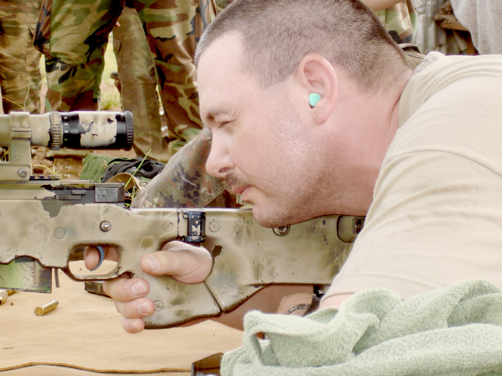 Tech. Sgt. James Gregg fires a rifle during joint service weapons training with the U.S. Navy SEALs and Cameroonian forces as part of African Partnership Station 2009 Sept. 29, 2009, in West Central Africa. Sergeant Gregg is a communication computer system operator with the 21st Air Mobility Operations Squadron. (U.S. Air Force photo) 