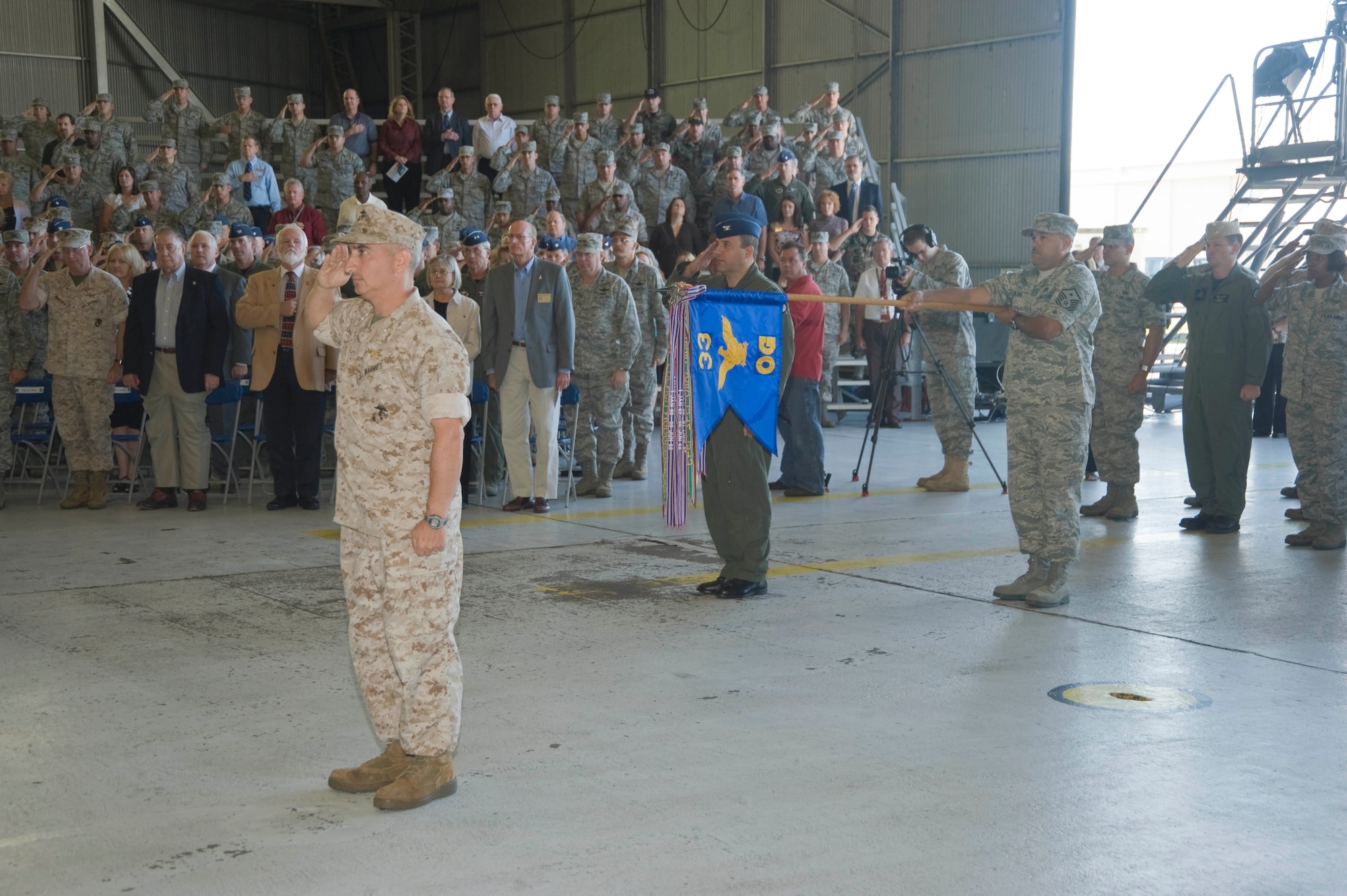 Marine Col. Arthur Tomassetti, 33rd Fighter Wing vice commander, and two flights under his command salute Col. David Hlatky, 33rd FW commander, at the redesignation ceremony marking the standup of the Air Force's first F-35 Joint Strike Fighter training unit. The 33rd FW "Nomads" now align under Air Education and Training Command and will be responsible for training pilots and mechanics on the F-35 Lightning II. (U.S. Air Force photo by Greg Murry)