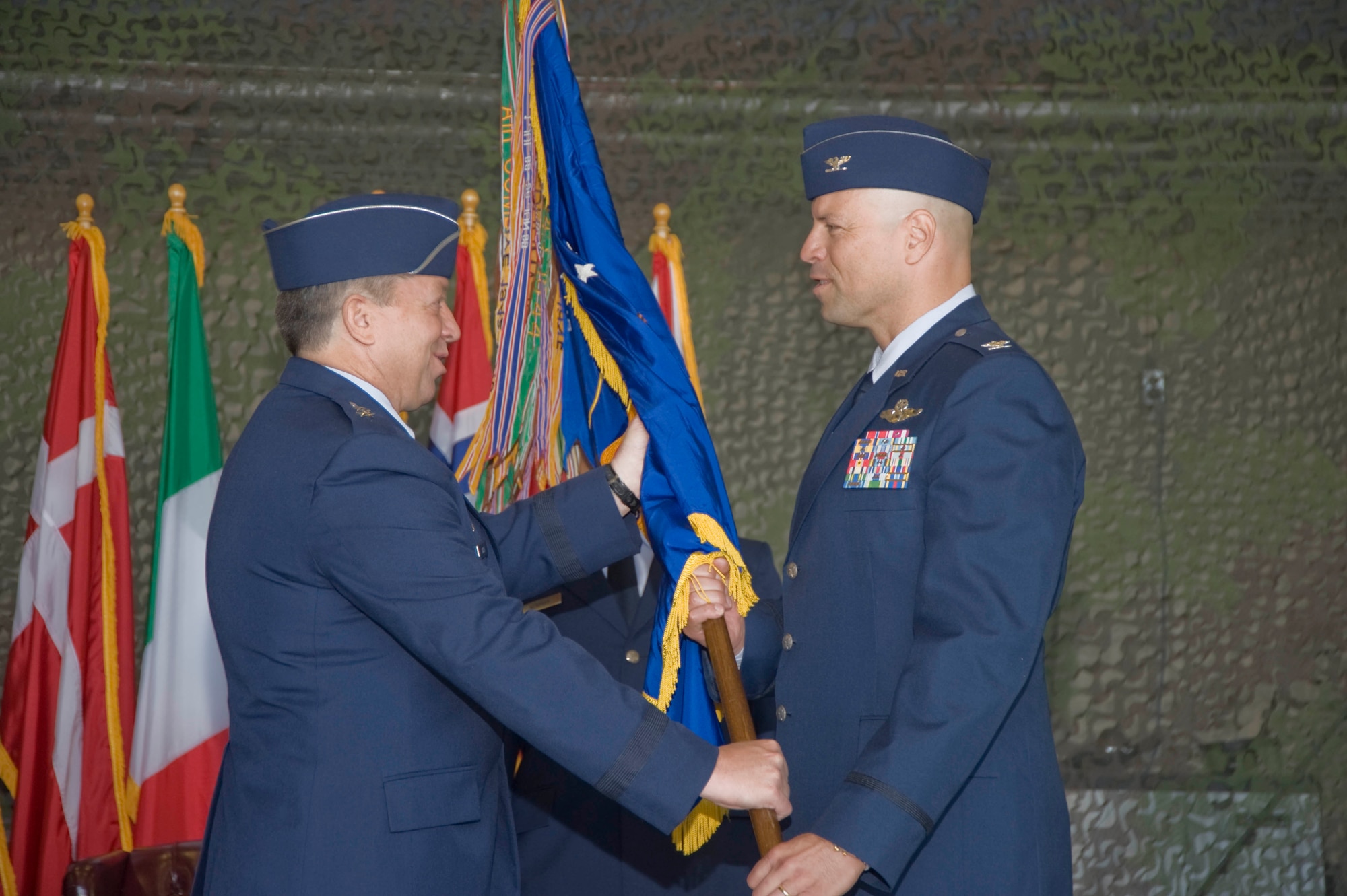 Maj. Gen. Gregory Feest, 19th Air Force commander, presents the 33rd Fighter Wing flag to Col. David Hlatky, 33rd FW commander, at the redesignation ceremony marking the standup of the Air Force's first F-35 Joint Strike Fighter training unit. The 33rd FW "Nomads" now align under Air Education and Training Command and will be responsible for training pilots and mechanics on the F-35 Lightning II. (U.S. Air Force photo by Greg Murry)