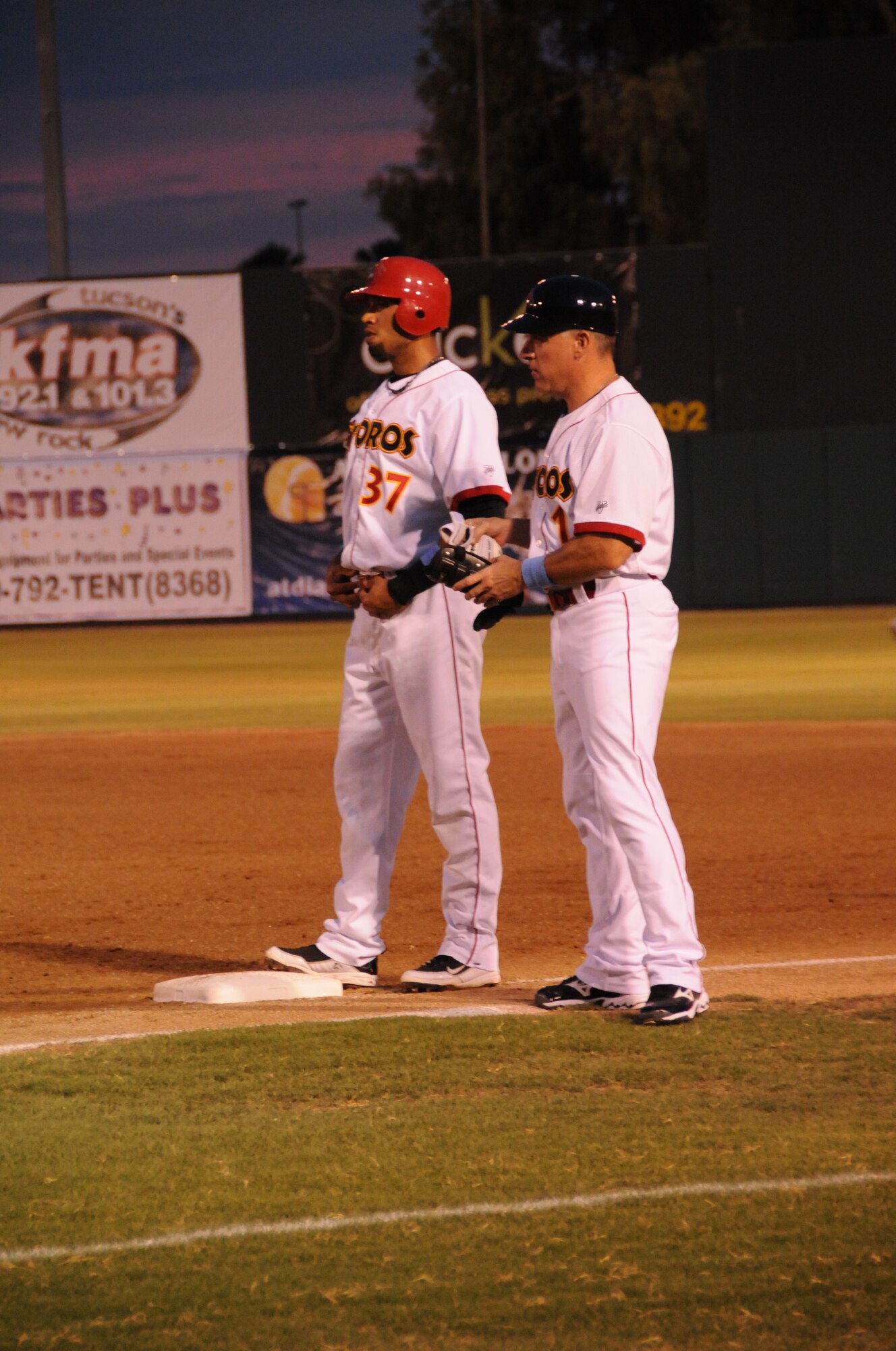 Col. (Dr.) James Balserak, right, coaches a Tucson Toros runner at first base during a game at Hi Corbett Field. (Courtesy photo)