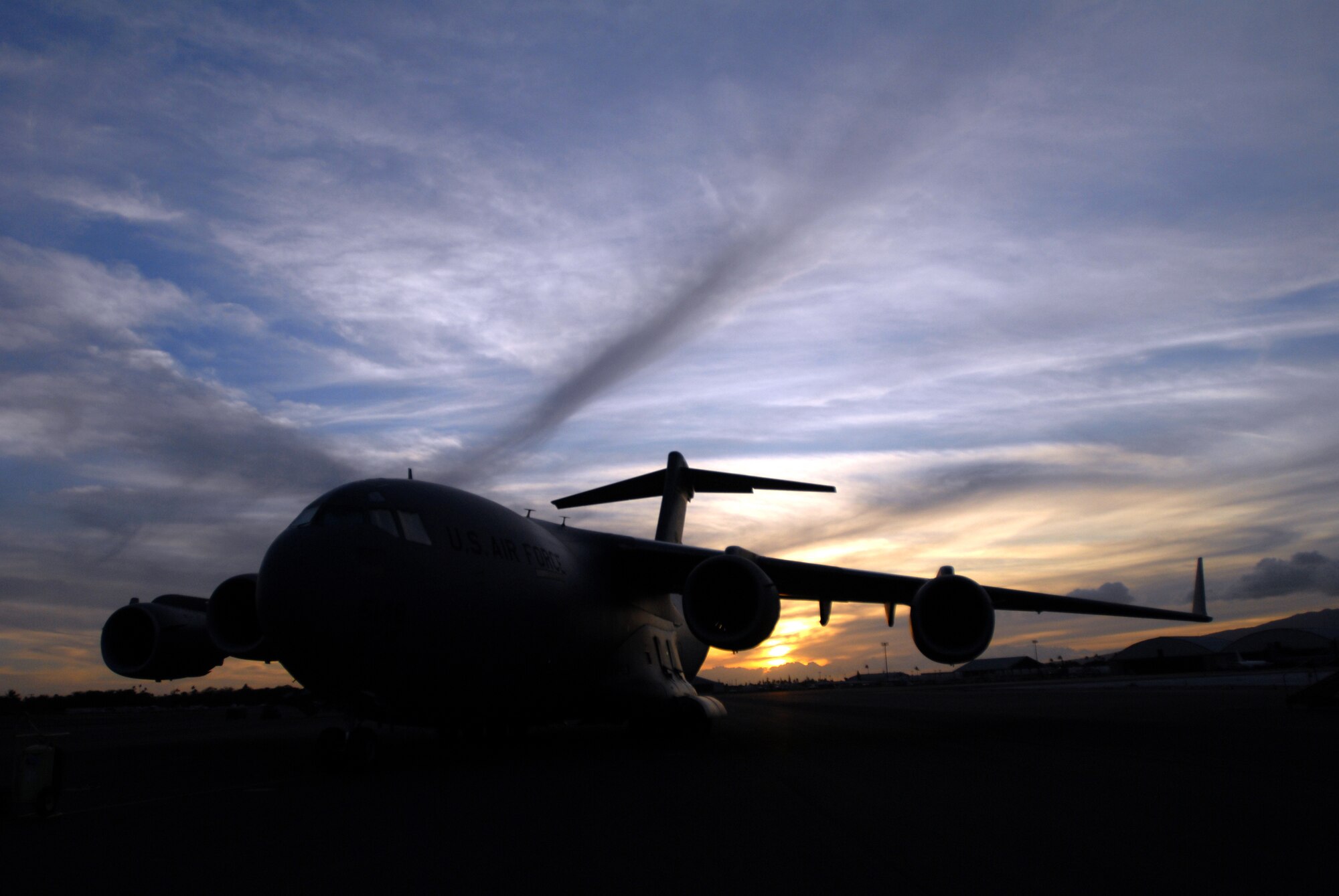 A C-17 Globemaster III sits as crews prepare to take off to deliver humanitarian supplies to the tsunami-devastated Samoa region in the South Pacific Sept. 30, 2009, at Hickam Air Force Base, Hawaii. A multiagency contingent from Hawaii, including active-duty Airmen at Hickam AFB, Soldiers with the Hawaii National Guard and Airmen with the Hawaii Air National Guard, took off bound for American Samoa with relief supplies and equipment to assist in the region. Reports indicate the islands have suffered greatly, villages are wiped out and more than a thousand residents and visitors are displaced. An undersea earthquake churned up tsunamis Sept. 29 that left more than 140 people dead in the Samoa region. More than 90 Airmen and Soldiers deployed from Hawaii for the humanitarian mission. (U.S. Air Force photo/Staff Sgt. Mike Meares)