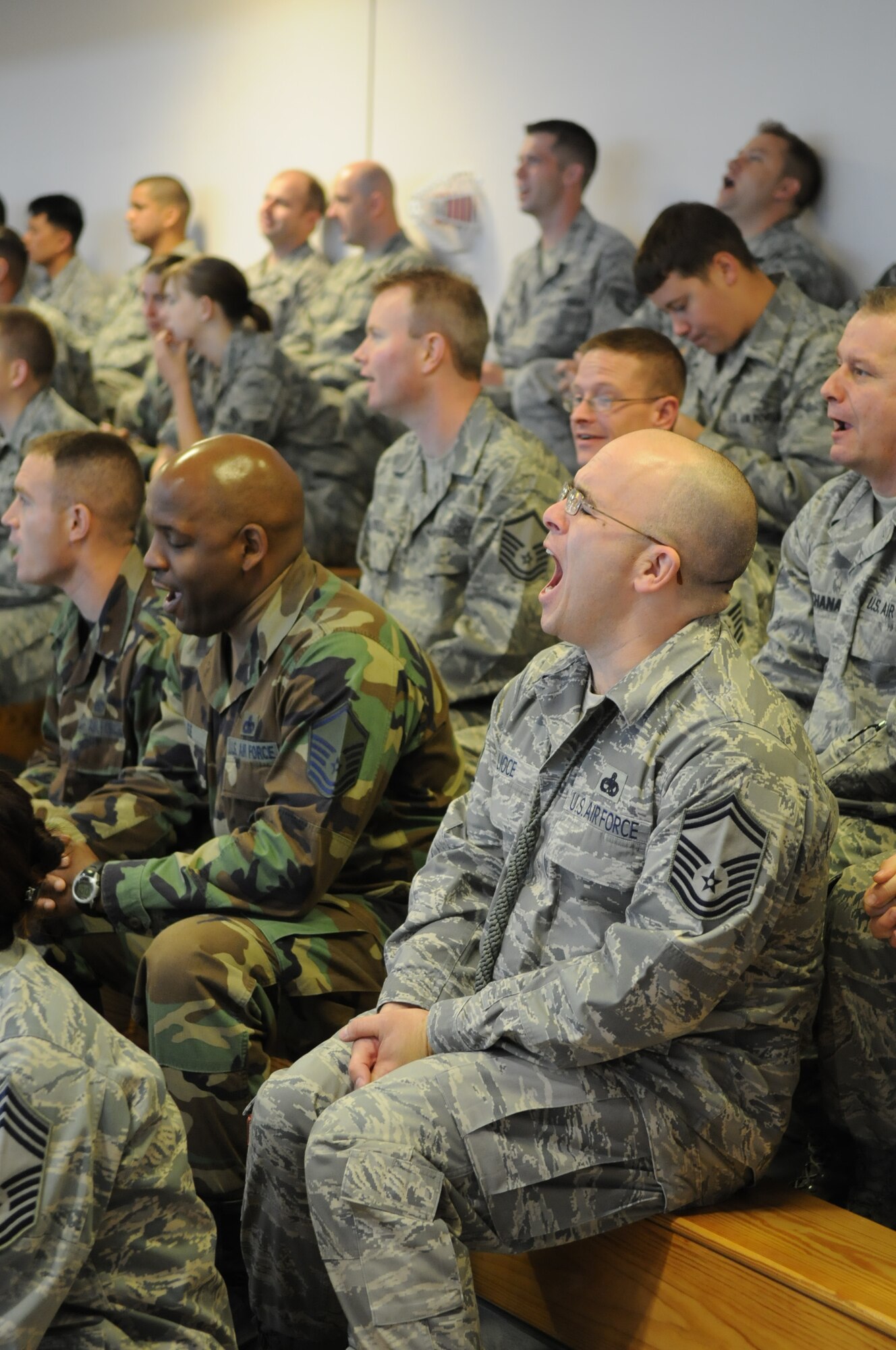 RAF MILDENHALL, England -- Senior Master Sgt. Michael Lioce, 100th Communications Squadron, and a crowd of hundreds scream the 100th Air Refueling Wing's new battle cry, "Where Eagles Dare!" at a pre-Operational Readiness Inspection pep rally Oct. 2.  The pep rally was led by Col. Chad Manske, 100th ARW commander, who motivated Airmen and reminded them that everyone is a participant in one way or another during the ORI.  (U.S. Air Force photo/Staff Sgt. Austin M. May)