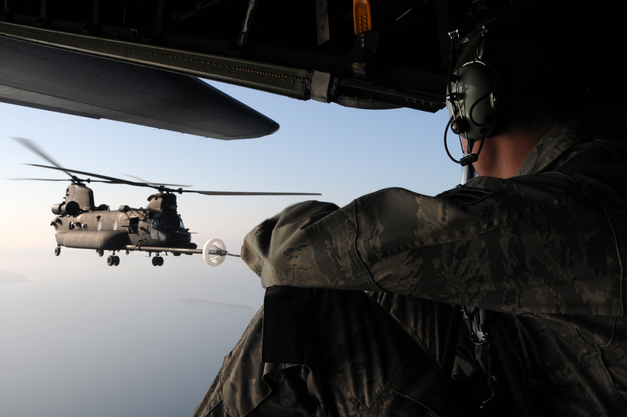ZADAR, Croatia — A crewmember assigned to 67th Special Operation Squadron, based at RAF Mildenhall, England, watches as an U.S Army MH-47 Chinook assigned to the 160th Special Operations Aviation Regiment (Airborne), Fort Campbell, Ky., is refueled by a MC-130P Shadow airplane as part of a helicopter aerial refueling mission over the Adriatic Sea as part of the Jackal Stone 2009 exercise being held here. (Special Operations Europe photo by Army Master Sgt. Donald Sparks)