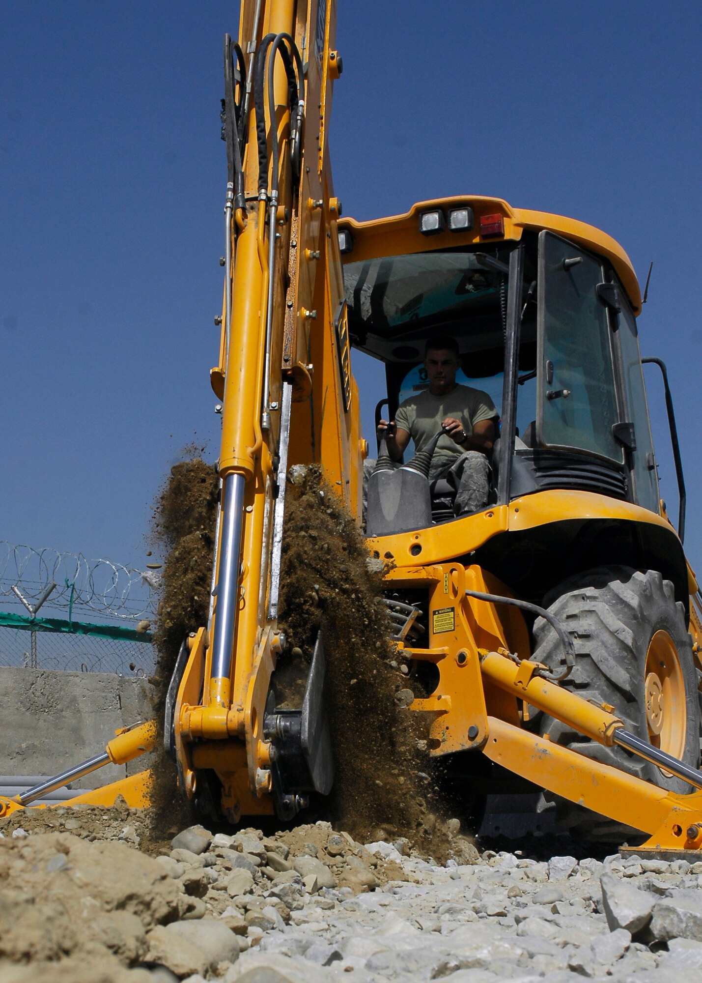 BAGRAM AIRFIELD, Afghanistan -- Staff Sgt. Denver Robison, a pavement equipment craftsman from the 455th Expeditionary Civil Engineering Squadron, digs a trench near the flightline to lay pipe here, Oct. 2, 2009.  The pipe is used as an easy way for the communications squadron to route the wiring that provides internet and phone services to new facilities.  Sergeant Robison is deployed from the Arkansas Air National Guard's 188th Fighter Wing CES, and hails from Fayetteville, Ark.  (U.S. Air Force photo/Senior Airman Felicia Juenke)