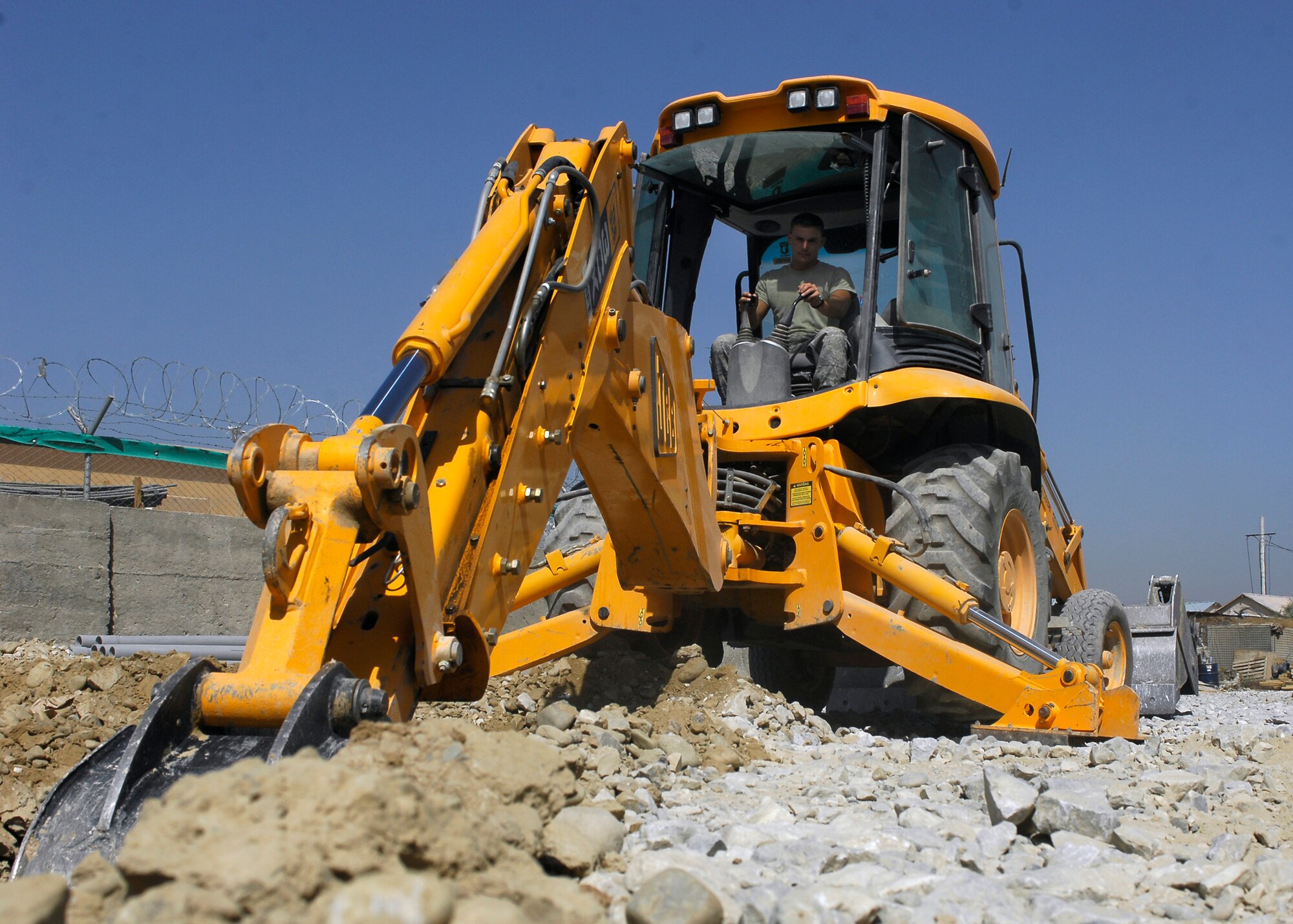 BAGRAM AIRFIELD, Afghanistan -- Staff Sgt. Denver Robison, a pavement equipment craftsman from the 455th Expeditionary Civil Engineering Squadron, digs a trench near the flightline to lay pipe here, Oct. 2, 2009.  The pipe is used as an easy way for the communications squadron to route the wiring providing internet and phone services to new facilities.  Sergeant Robison is deployed from the Arkansas Air National Guard's 188th Fighter Wing CES, and hails from Fayetteville, Ark.  (U.S. Air Force photo/Senior Airman Felicia Juenke)