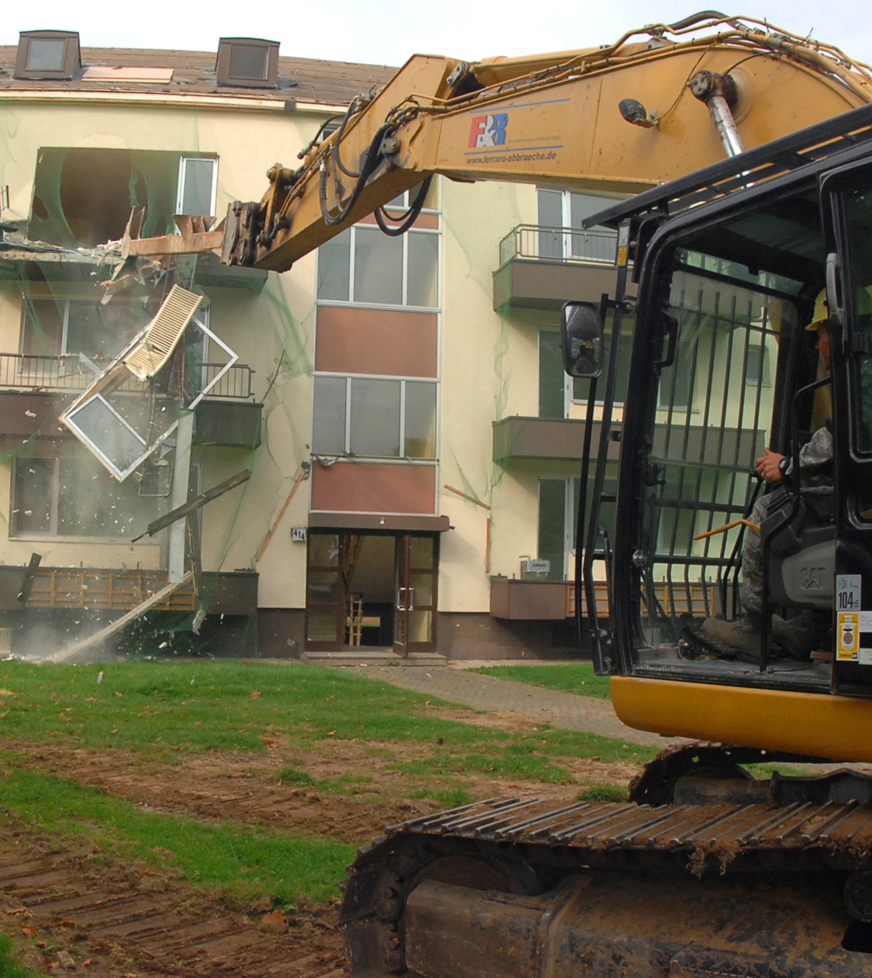 SPANGDAHLEM AIR BASE, Germany – An old base housing unit here is demolished with an excavator Oct. 1. This building, along with five others, will be torn down to make way for a new child development center to support continued growth as part of Spangdahlem 2015, where Bitburg Annex’s assets will transition to Spangdahlem.  Ground breaking on the CDC will be in spring 2010 and is estimated to be completed in 2011. (U.S. Air Force photo by Airman 1st Class Nick Wilson)