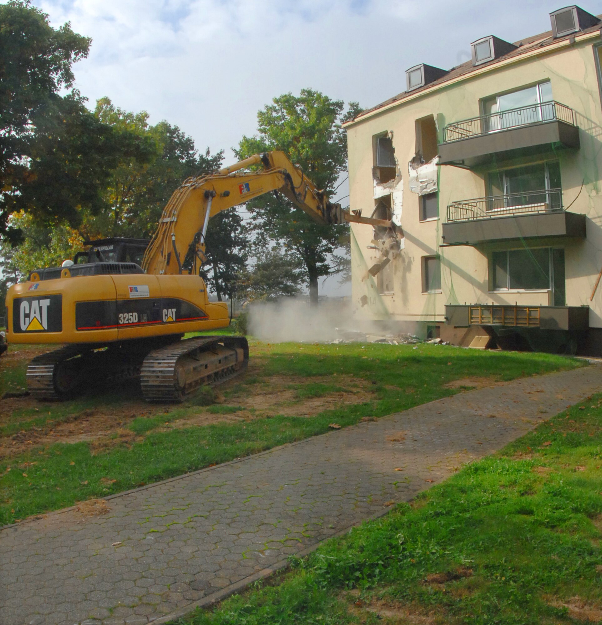 SPANGDAHLEM AIR BASE, Germany – An old base housing unit here is demolished with an excavator Oct. 1. This building, along with five others, will be torn down to make way for a new child development center to support continued growth as part of Spangdahlem 2015, where Bitburg Annex’s assets will transition to Spangdahlem.  Ground breaking on the CDC will be in spring 2010 and is estimated to be completed in 2011. (U.S. Air Force photo by Airman 1st Class Nick Wilson)