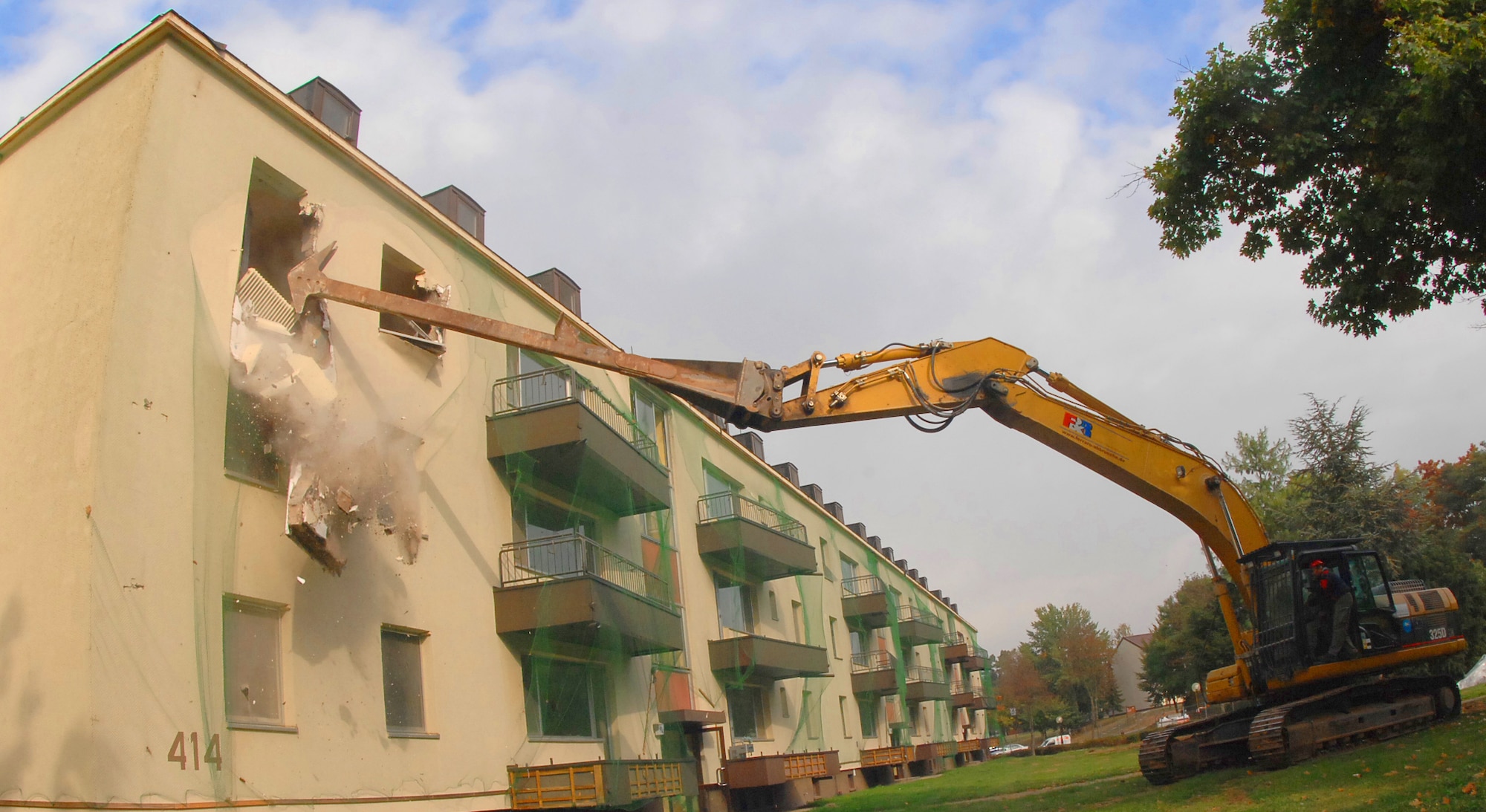 SPANGDAHLEM AIR BASE, Germany – Col. Jodine Tooke, 52nd Mission Support Group commander, uses an excavator to demolish an old base housing unit here Oct. 1. This building, along with five others, will be torn down to make way for a new child development center to support continued growth as part of Spangdahlem 2015, where Bitburg Annex’s assets will transition to Spangdahlem.  Ground breaking on the CDC will be in spring 2010 and is estimated to be completed in 2011. (U.S. Air Force photo by Airman 1st Class Nick Wilson)