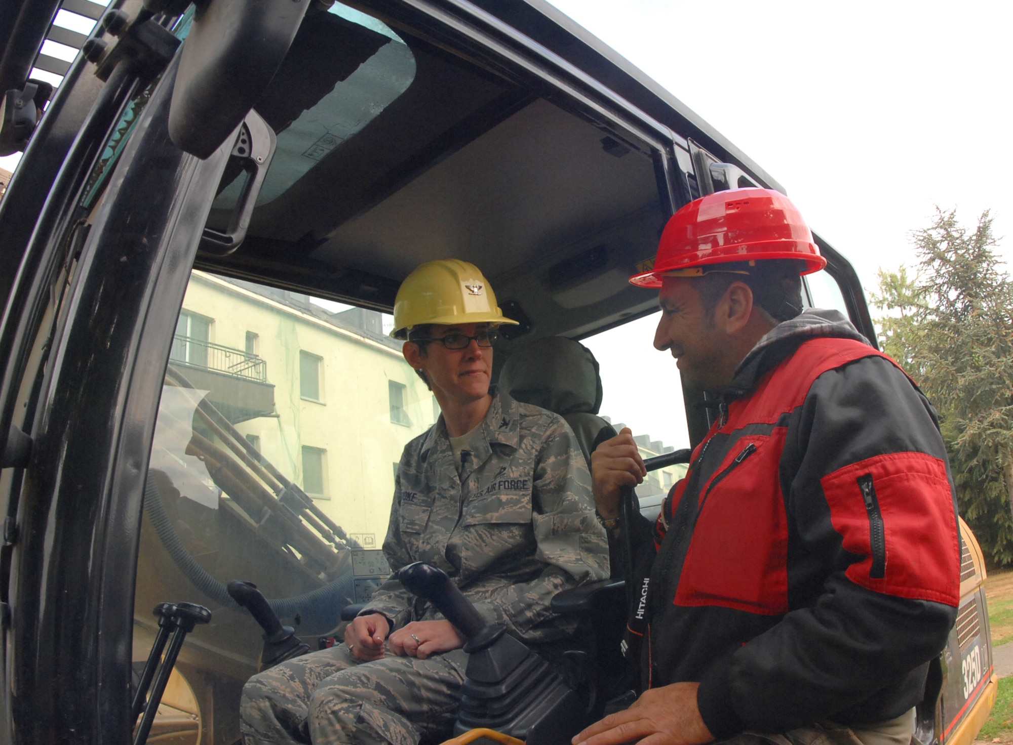 SPANGDAHLEM AIR BASE, Germany – Col. Jodine Tooke, 52nd Mission Support Group commander, is briefed by an equipment operator from the demolition company Ferraro Industriemontageund Abbruch GmbH prior to demolishing building 414 here Oct. 1. This building, along with five others, will be torn down to make way for a new child development center to support continued growth as part of Spangdahlem 2015, where Bitburg Annex’s assets will transition to Spangdahlem.  Ground breaking on the CDC will be in spring 2010 and is estimated to be completed in 2011. (U.S. Air Force photo by Airman 1st Class Nick Wilson)