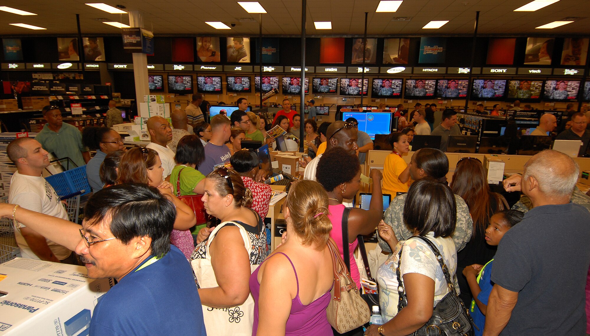 Hundreds of customers browse the Power Zone section of Kadena's new base exchange shortly after the grand opening ceremony Oct. 2. The new 344,000 square foot exchange is the largest Army and Air Force Exchange Service shopping center in the Pacific and second largest in the world. Shuttle buses will run from Four Diamonds baseball field parking lot and Ryukyu Middle School every hour on the hour and return from the shopping center every hour on the half hour until 9:30 p.m. Oct. 2.  Shuttles will start again at 9 a.m. Oct. 3 and 4, and will run the same route in addition to the Kadena medical clinic parking lot. (U.S. Air Force/Staff Sgt. Jason Lake)