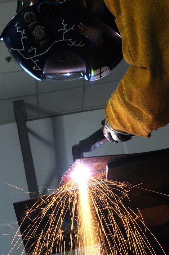 Staff Sgt. Andrew Davis, 39th Maintenance Squadron fabrications shop assistant chief, uses a plasma-cutter to slice through a piece of steel Tuesday, Sept. 29, 2009 at the Incirlik Air Base fabrications shop. Plasma-cutters work by sending a pressurized gas, such as nitrogen, argon or oxygen, through a small channel creating a spark that reduces metal to molten slag. (U.S. Air Force photo/Senior Airman Erica Picariello)