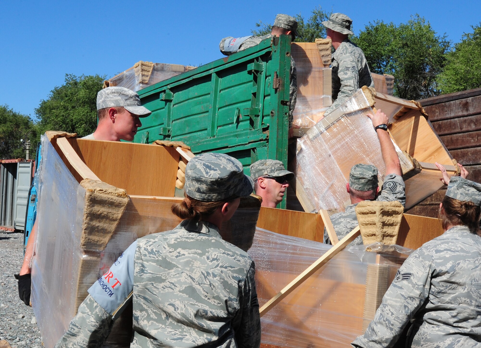 TRANSIT CENTER AT MANAS, Kyrgyzstan -- Airmen from the 376th Expeditionary Civil Engineer and Force Support Squadrons load desks to be taken to local villages from the Transit Center. Over three-hundred donated desks were loaded and taken to Manas' nearby villages and schools. (U.S. Air Force photo/Senior Airman Steele C. G. Britton)