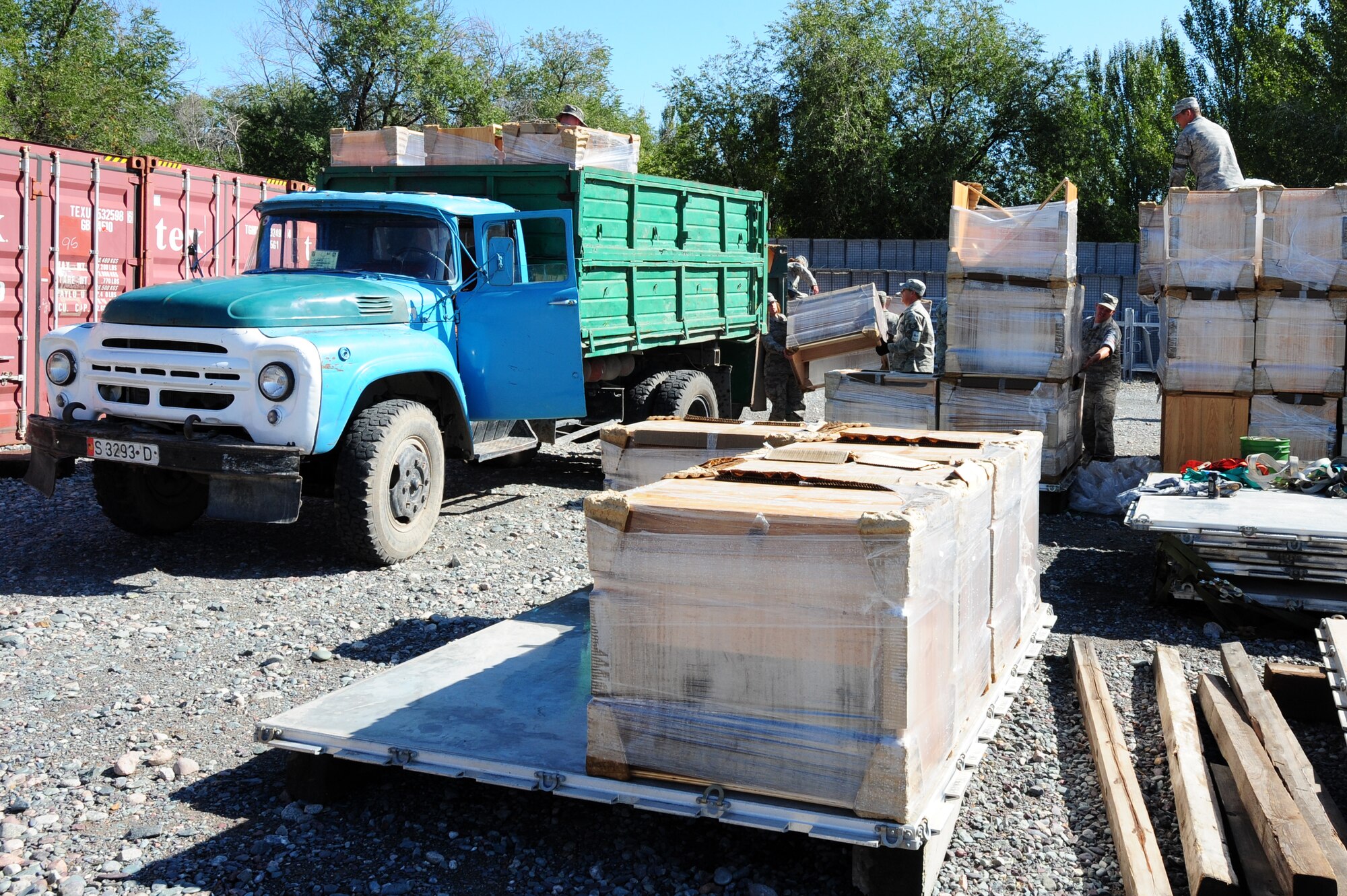 TRANSIT CENTER AT MANAS, Kyrgyzstan -- Desks are loaded onto trucks to be taken to local villages and schools from the Transit Center. (U.S. Air Force photo/Senior Airman Steele C. G. Britton)