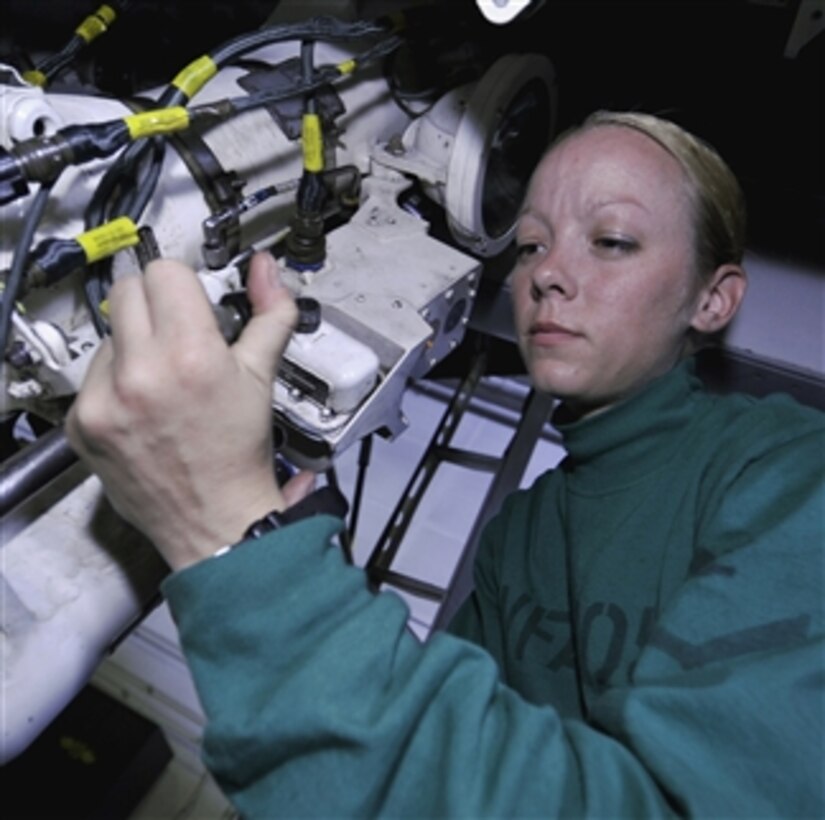 U.S. Navy Petty Officer 3rd Class Rita Ashcroft replaces the nose wheel steering harness on an F/A-18E Super Hornet aircraft aboard the aircraft carrier USS Harry S. Truman (CVN 75) in the Atlantic Ocean on Sept. 19, 2009.  The Truman is underway participating in Joint Task Force Exercise, a scenario-driven tactical exercise.  