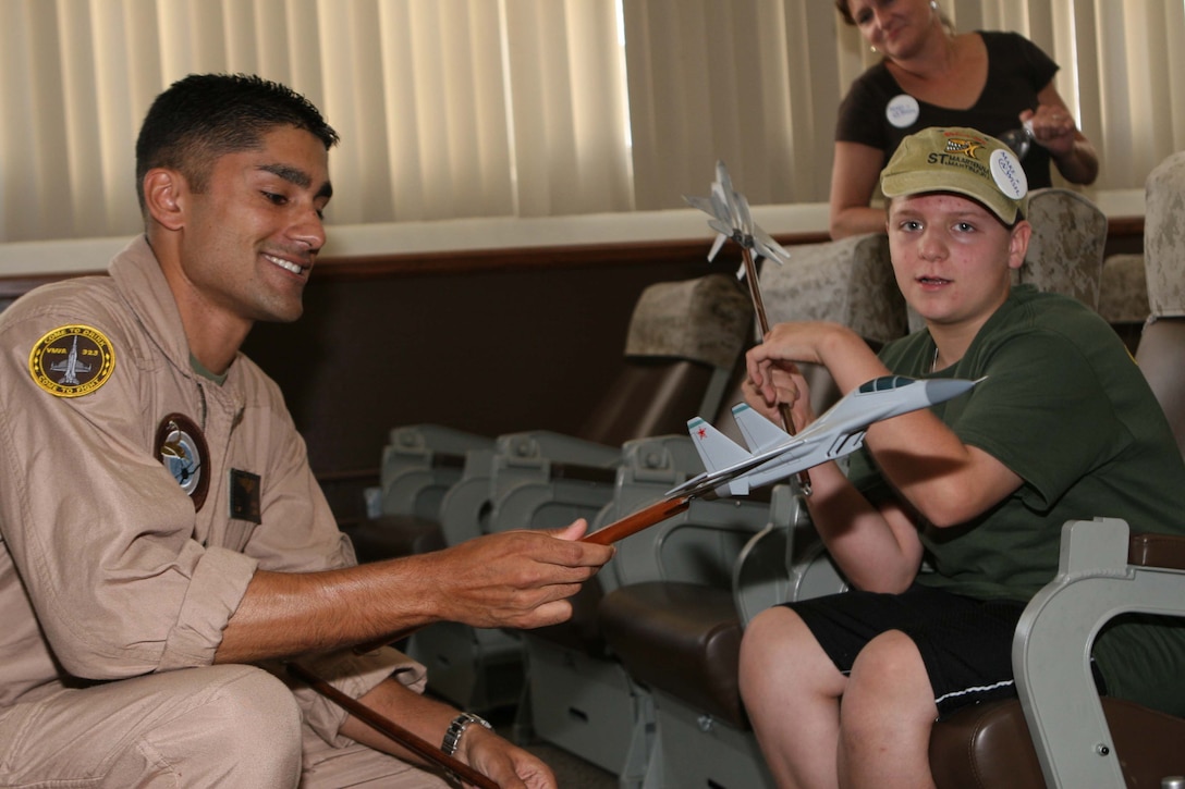 Capt. Taj Sareen, a Marine Fighter Attack Squadron 323 F/A-18 pilot, shows Jared Hyams the model fighter jets pilots use during briefs. The Make-A-Wish foundation granted Hyams his wish to attend the 2009 Marine Corps Air Station Miramar Air Show Oct. 1st.