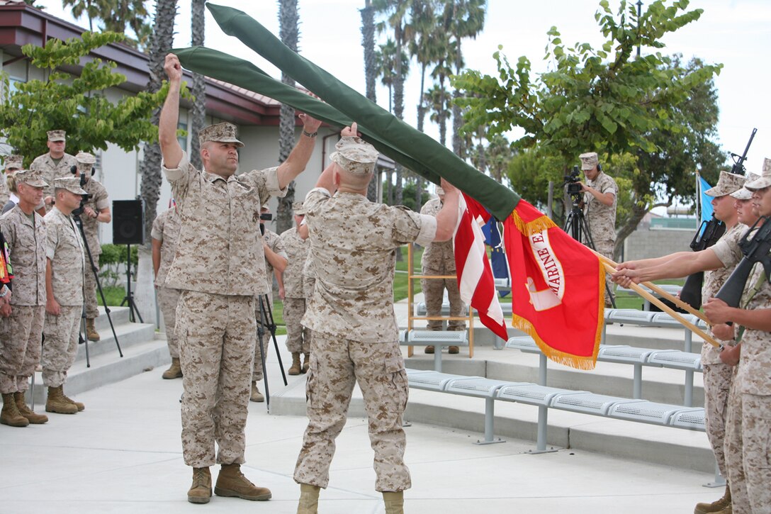 Brigadier General Joseph L. Osterman, 1st Marine Expeditionary Brigade Commanding General, and Master Gunnery Sgt. William G. Ouimette, 1st Marine Expeditionary Brigade Operations Chief, uncase the colors during the 1st MEB Reactivation Ceremony at Camp Pendleton, Calif., on Oct. 2.  The uncasing of the colors signifies the reactivation of the 1st MEB and the beginning of preparation for its scheduled 12-month deployment in the spring of 2010 in support of Operation Enduring Freedom in Afghanistan.  During the upcoming deployment, the Marines and sailors of the 1st MEB will be conducting counterinsurgency operations and training Afghan national security forces.