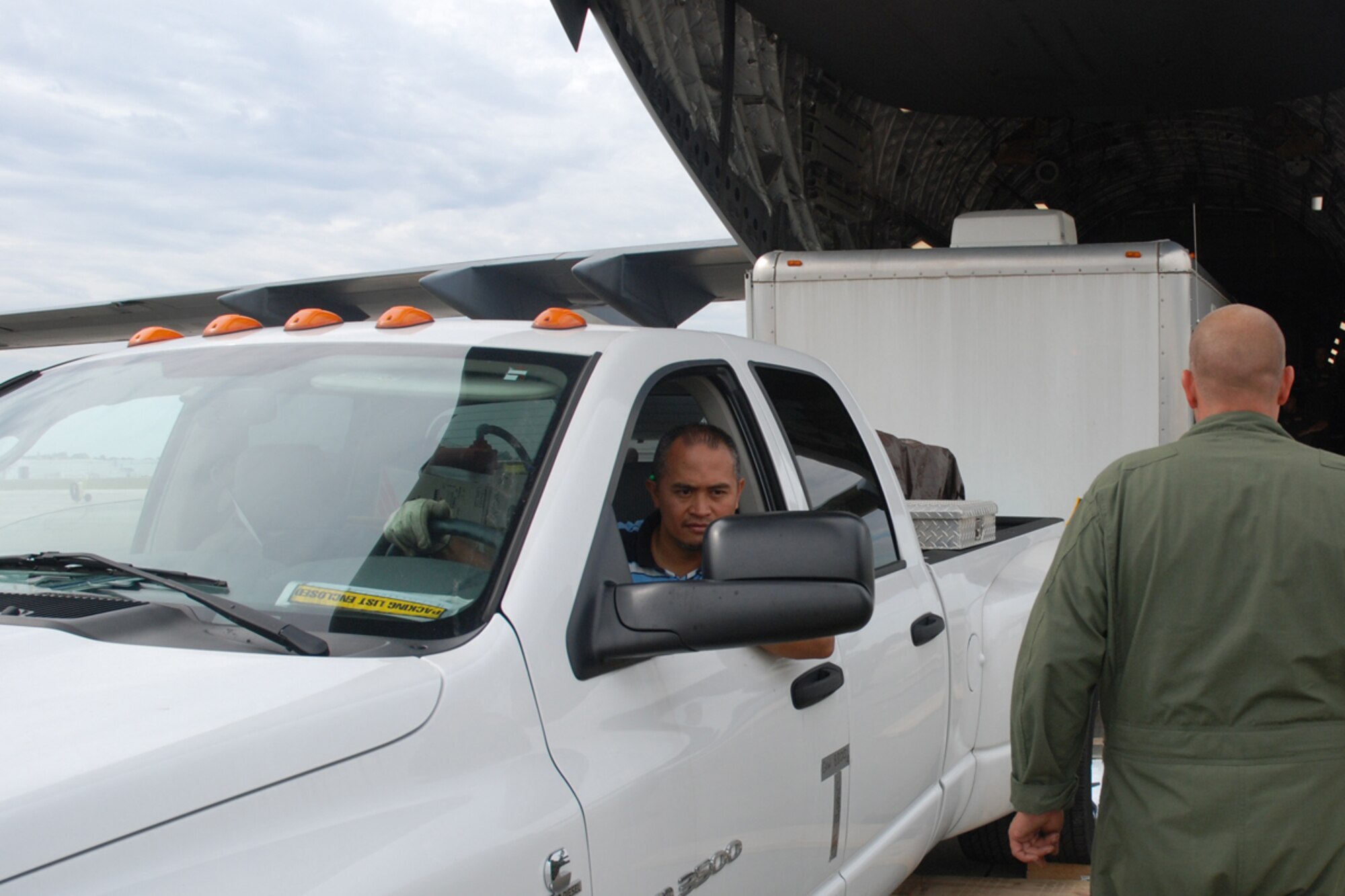 Reynante Rivera from the Traffic Management Office, 94th Logistics Readiness Squadron, loads FEMA communication equipment and supplies on a C-17 aircraft at Dobbins Air Reserve Base, Ga. Oct. 2. FEMA will set up a command station in Hawaii to communicate with aircraft delivering humanitarian supplies to the tsunami-devastated Samoa region in the South Pacific. (U.S. Force photo/Tech. Sgt. James Branch)