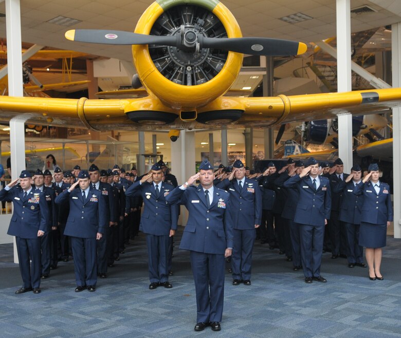 Led by Lt. Col. Jason Werchan, 479th Flying Training Group deputy commander, the members of the troop formation render their salutes during the playing of the National Anthem at the activation ceremony of the 479th FTG Oct. 2 in the National Museum of Naval Aviation at NAS Pensacola, Fla. (U.S. Air Force photo by Joel Martinez)