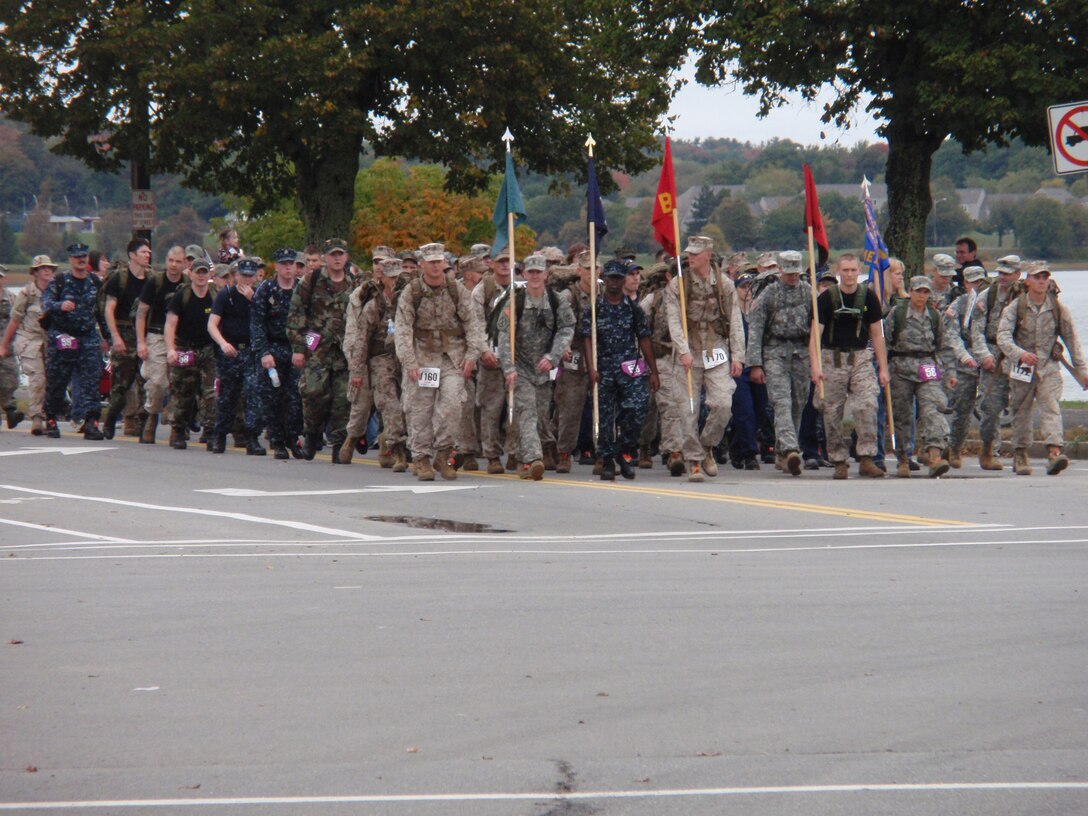 Members of the armed forces branches, along with families of service members who have been killed in combat, march together as they approach the finish line of the Maine Marathon Tribute March Oct. 4 in Portland, Maine.