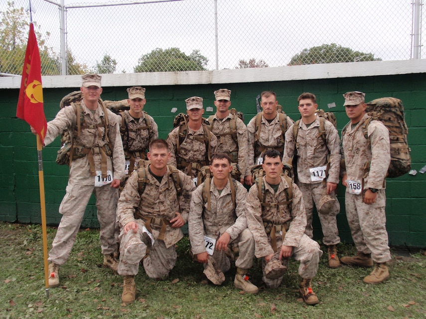 (From left to right, back to front) Cpl. J. Pierre DeForest, 1st Lt. Lucian Mossbarger, Cpl. Jeremy Shurtleff, Lance Cpl. Sam Smalley, Sgt. Mike Gripp, Cpl. William Mauro, 1st Lt. Nick De Greggorio, Staff Sgt. Chris Singley, Cpl. Cody May and Lance Cpl. Daniel Stice, all members of Company B, 3rd Light Armored Reconnaissance Battalion, pose at the finish line of the Maine Marathon Tribute March Oct. 4 in Portland, Maine.