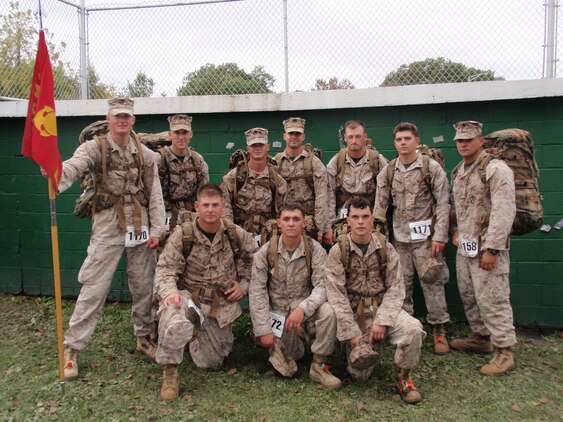(From left to right, back to front) Cpl. J. Pierre DeForest, 1st Lt. Lucian Mossbarger, Cpl. Jeremy Shurtleff, Lance Cpl. Sam Smalley, Sgt. Mike Gripp, Cpl. William Mauro, 1st Lt. Nick De Greggorio, Staff Sgt. Chris Singley, Cpl. Cody May and Lance Cpl. Daniel Stice, all members of Company B, 3rd Light Armored Reconnaissance Battalion, pose at the finish line of the Maine Marathon Tribute March Oct. 4 in Portland, Maine.