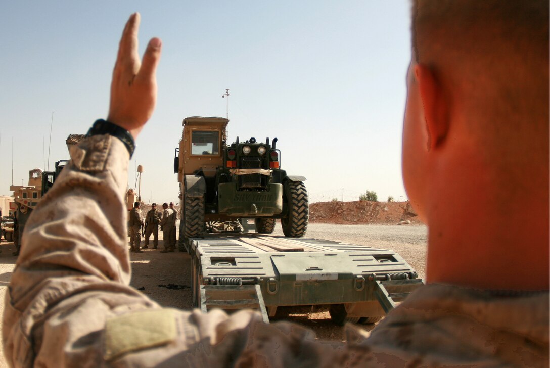 Lance Cpl. Nicholas L. Hornborg, a heavy equipment operator with 4th Platoon, Transportation Support Company, Combat Logistics Battalion 46, guides a forklift off of a truck during a resupply and retrograde mission at Trebil, Iraq, Oct. 4, 2009.  The platoon has been conducting resupply and retrograde missions out of Camp Korean Village, Iraq, since taking over for CLB-7 in early September.