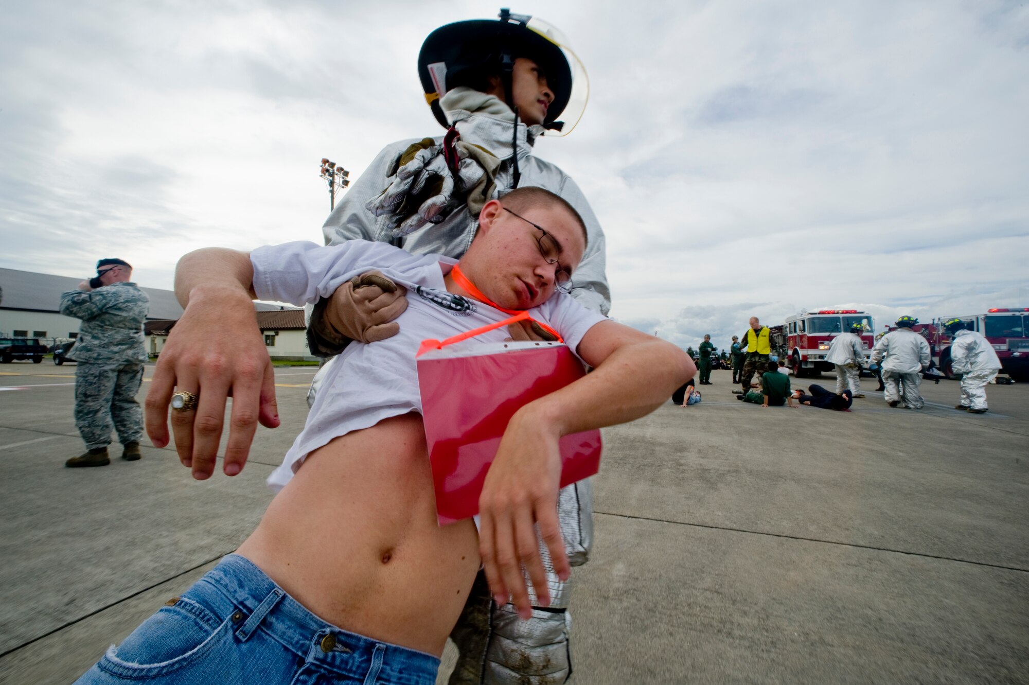 MISAWA AIR BASE, Japan -- Airman 1st Class Abraham Espinosa, 35th Civil Engineer Squadron firefighter, transports a simulated victim during a major accident response exercise Sept. 29 on the base flightline. Participants from many units across base took part in the exercise to help prepare for the Misawa Air Festival scheduled for Oct. 18. (U.S. Air Force photo/Senior Airman Jamal D. Sutter)