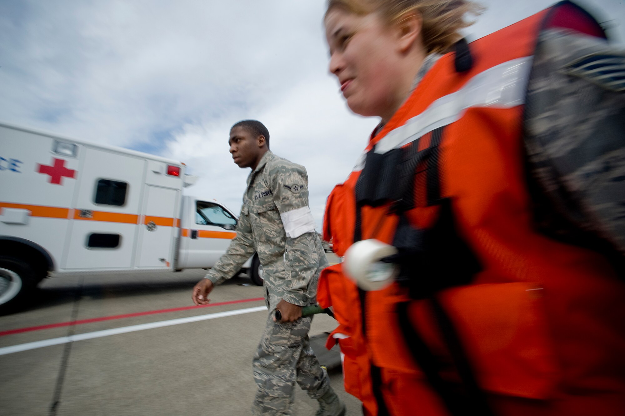 MISAWA AIR BASE, Japan -- Airman Joe Crockett, 35th Medical Support Squadron out-patient records technician, and Tech. Sgt. Tanya Jacquez, 14th Fighter Squadron medical element, transport a simulated victim during a major accident response exercise Sept. 29 on the base flightline. The exercise was geared to prepare the base in the event of a mishap during the Misawa Air Festival scheduled for Oct. 18. (U.S. Air Force photo/Senior Airman Jamal D. Sutter)