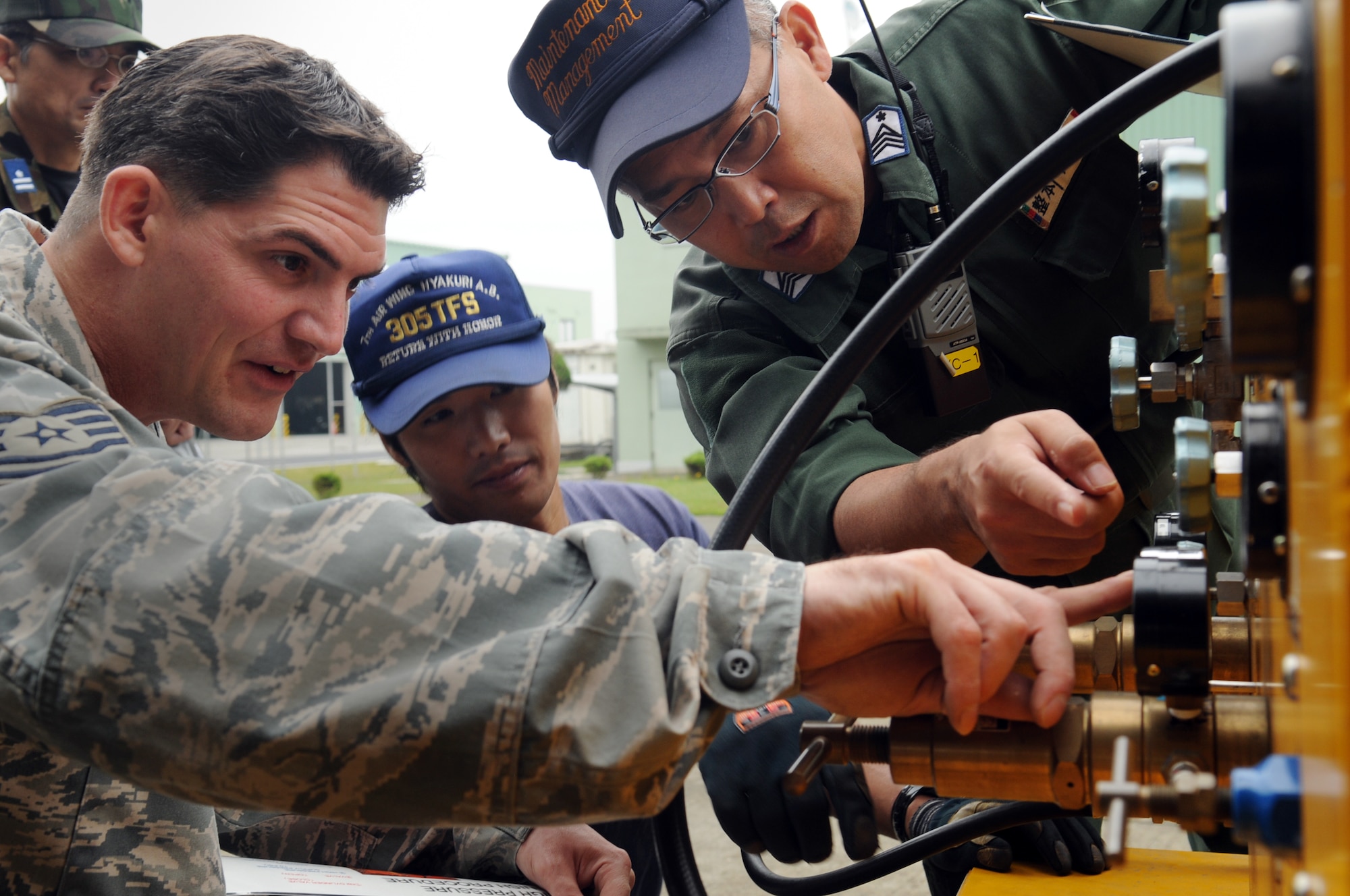Technical Sergeant Kevin Charrier, an expeditor with the 67th Aircraft Maintenance Unit, Kadena Air Base, Japan, recieves training from members of the Japan Air Self Defense Force on Aerospace Ground Equipment they will use during their visit to Hyakuri Air Base, Japan, Oct. 03. The visit is part of an Aviation Training Relocation exercise between Kadena Air Base, Okinawa and Japan Air Self Defense Force and takes place from 5-9 Oct. 2009.