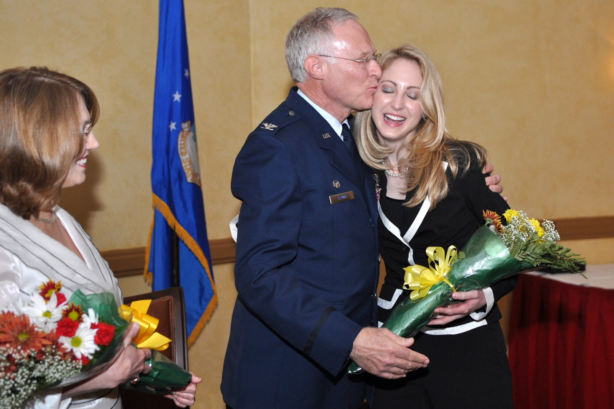 Colonel Robert L. Savory plants a kiss on his daughter, Dr. Stephanie Savory during a retirement ceremony at Barksdale Air Force Base, La., October 3, 2009. Colonel Edmund Walker, 917th Wing, commander, presided over the ceremony which marked the end of the military career of Colonel Savory, as he was finally shoved out the door to the ranks of the retired after more than 32 years of honorable military service to his country and community. Until his retirement, Colonel Savory had been the Medical Director for the 917th Wing since 1999. (U.S. Air Force photo/Tech. Sgt. Jeff Walston)