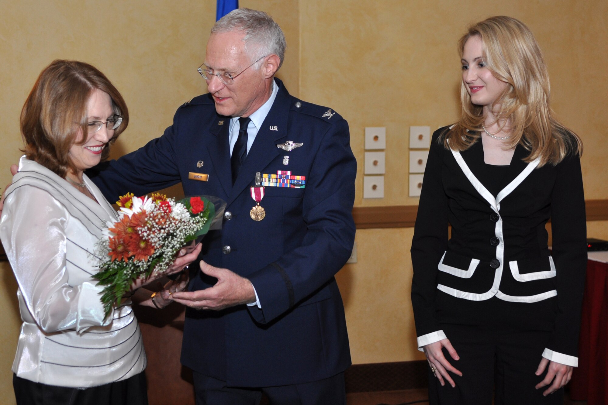 Colonel Robert L. Savory presents flowers to his wife Sandra during a retirement ceremony at Barksdale Air Force Base, La., October 3, 2009. Colonel Edmund Walker, 917th Wing, commander, presided over the ceremony which marked the end of the military career of Colonel Savory, as he was finally shoved out the door to the ranks of the retired after more than 32 years of honorable military service to his country and community. Until his retirement, Colonel Savory had been the Medical Director for the 917th Wing since 1999. (U.S. Air Force photo/Tech. Sgt. Jeff Walston)