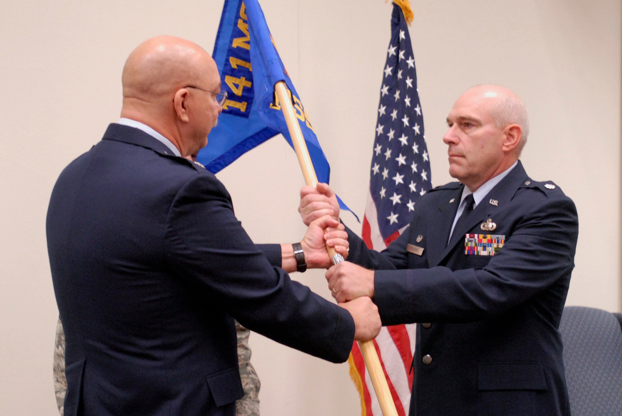 Air National Guard Lt. Col. Mark Fischer,141st Force Support Squadron commander, accepts the guideon from Lt. Col. Michael Hirst, 141st Mission Support Group commander, during the stand-up ceremony for the new 141st Force Support Squadron, Fairchild AFB, Wash., Oct. 5, 2009. (U.S. Air Force photo by Staff Sgt. Anthony Ennamorato/Released)