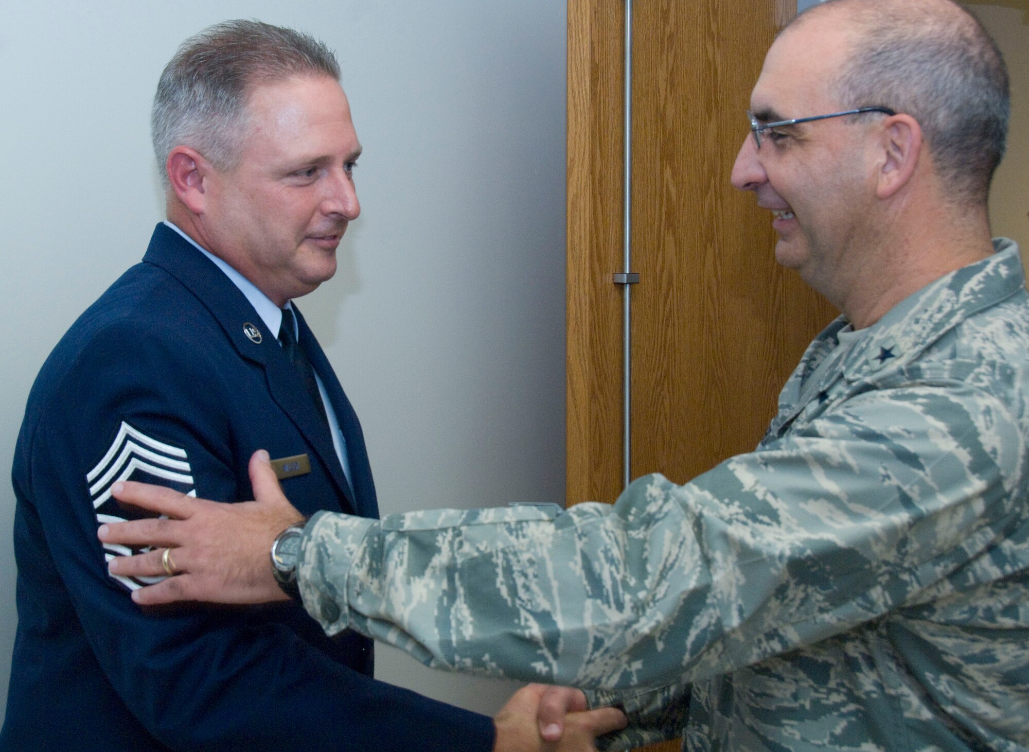 Brig. Gen. James Muscatell, 403rd Wing commander, congratulates Chief Master Sgt. Eugene "Lee" Wilcox on his promotion. Chief Wilcox enlisted in the Air Force 27 years ago on the active-duty side. He joined the 403rd Wing in 1995 and has served in various capacities in the 403rd Civil Engineering Squadron, most recently as the chief of operations.