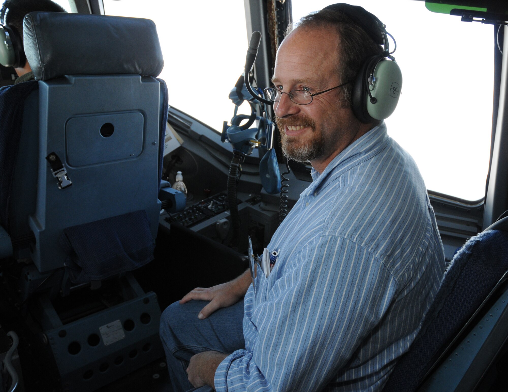 John Rogan admires the view from the cockpit of a C-17 GlobeMaster III during a two-hour flight on Employer Appreciation day, Oct. 3. Along with riding in a C-17, Mr. Rogan joined nearly 25 employers of 512th Airlift Wing reservists in learning more about the wing's mission and touring the base, here. (U.S. Air Force photo/Staff Sgt. Steve Lewis) 