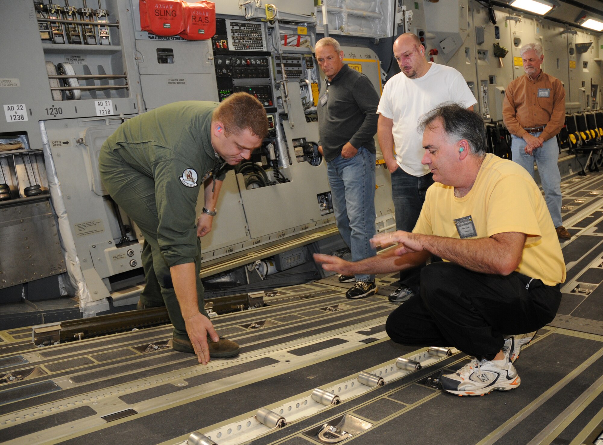 Tech. Sgt. John Hemmerlein, 312th Airlift Squadron, shows features of the ramp of a C-17 Globemaster III to employers of 512th Airlift Wing reservists during Employer Appreciation Day, Oct. 3. Nearly 25 employers attended the event, where they learned more about the wing's mission, toured the base and participated in a C-7 Globemaster III flight. (U.S. Air Force photo/Staff Sgt. Steve Lewis) 