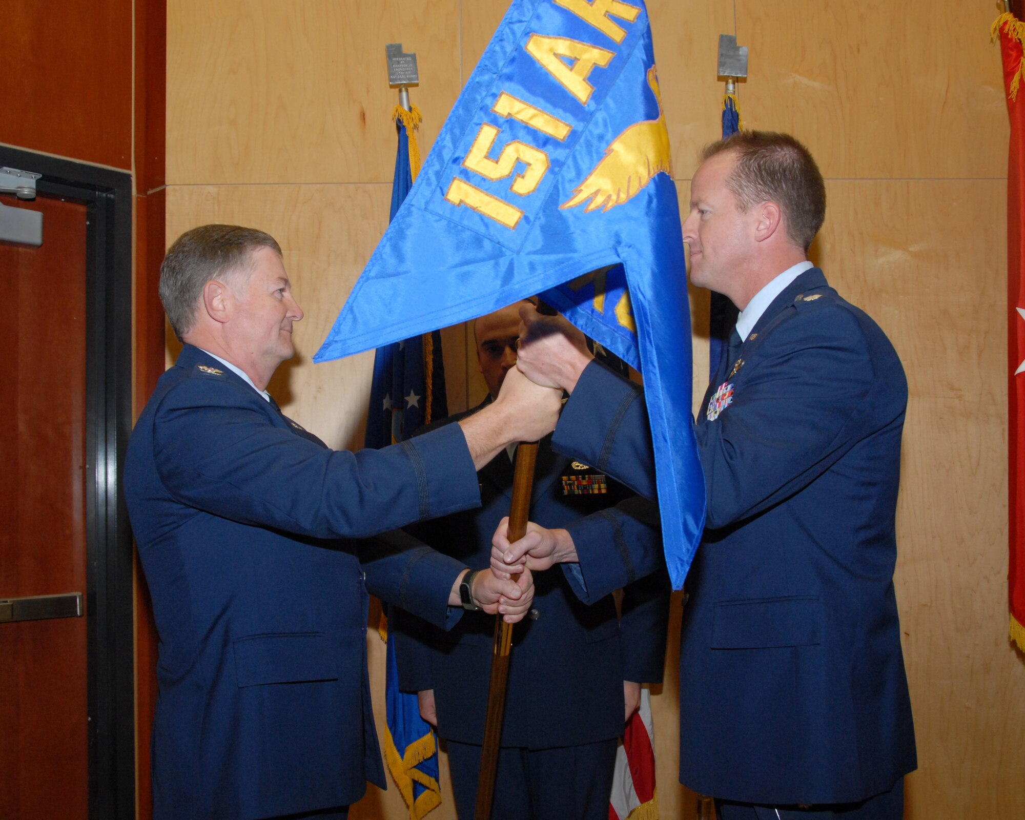 Lt. Col. Nate Nelson accepts command of the 151st Maintenance Group from Col. Kelvin Findlay, 151st Air Refueling Wing commander, during a change of command ceremony held on October 4 at the Utah Air National Guard base.  Change of command ceremonies are a time-honored tradition symbolizing the continuity of authority as the command is passed from one individual to another.  Col. Ron Blunck is the outgoing commander. U.S. Air Force photo by Staff Sgt. Emily Monson.
