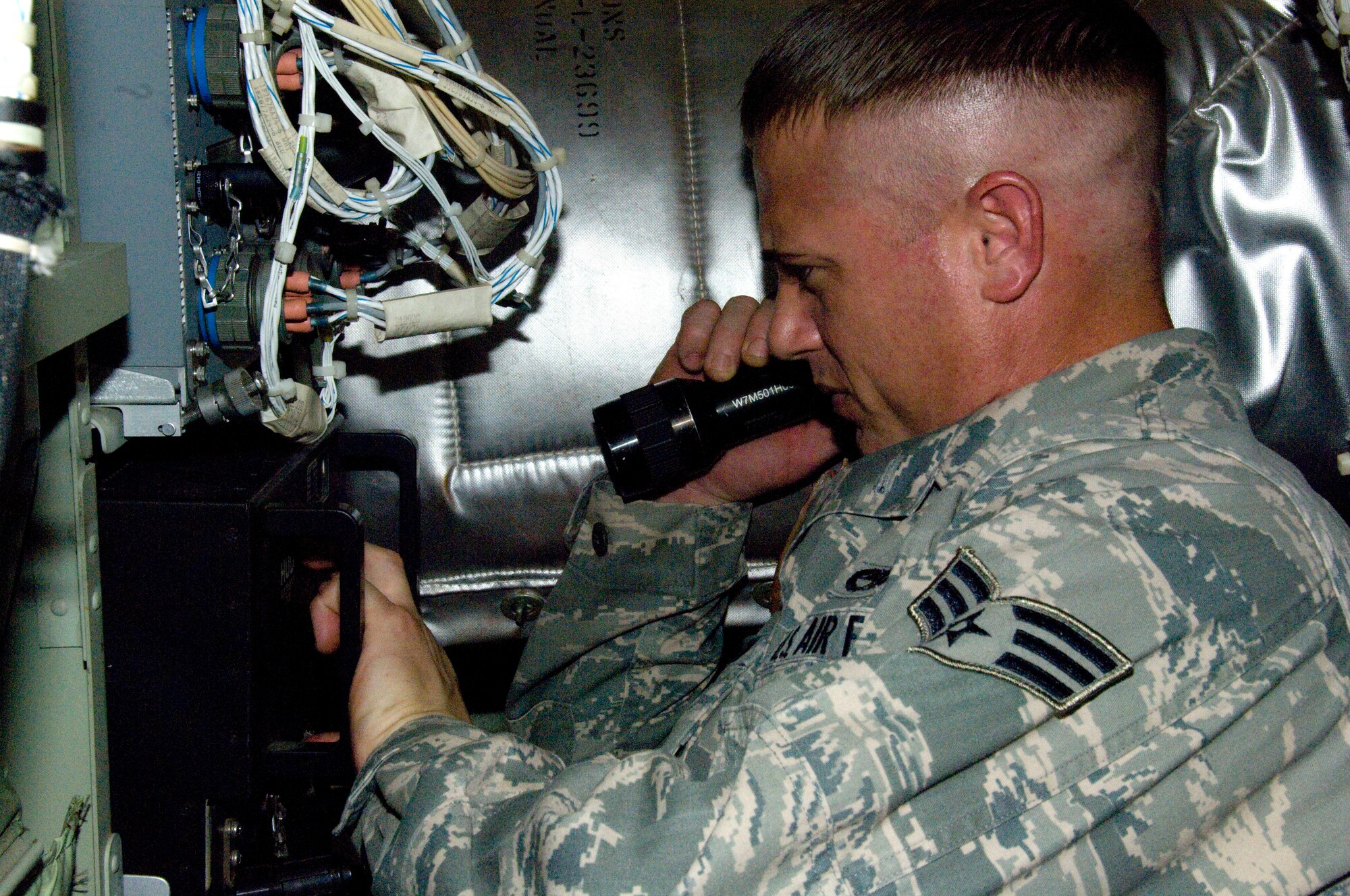 Sometimes the work environment can get a little cramped on the Hurricane Hunters' WC-130Js. Senior Airman Harlon Patton, 403rd Avionics Flight instruments/flight control systems specialist, performs an internal bit test for the co-pilot's Heads-Up Display. Airman Patton also is partipating in the Seasonal Training Program for the Avionics Flight. As a prior service member who performed this particular job on active-duty side, Airman Patton only need to complete nine nmonths of training instead of a full year.