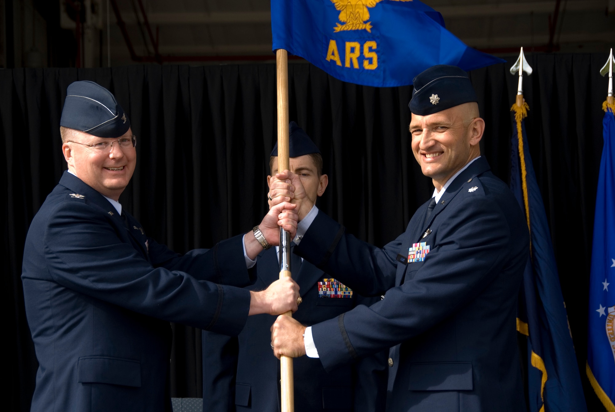Colonel Billy R. Langford (left), 22nd Operations Group Commander, McConnell Air Force Base, Kansas, presents the 64th Air Refueling Squadron's guidon to Lieutenant Colonel Christopher D. Leist, symbolizing Lt. Col. Leist's assumption of command of the 64th ARS.  Lt. Col. Leist's assumption of command coincides with the activation of the 64th ARS at Pease Air National Guard Base, New Hampshire, on October 2nd, 2009. The 64th ARS is collocated with the 157th Air Refueling Wing at Pease ANGB, but is assigned to headquarters 22nd OPG,  McConnell AFB, KS.  This events marks the first time since the 1991 closure of Pease AFB that an active duty Air Force unit has returned to Pease.  (U.S. Air Force photo/Staff Sgt. Curtis J. Lenz)