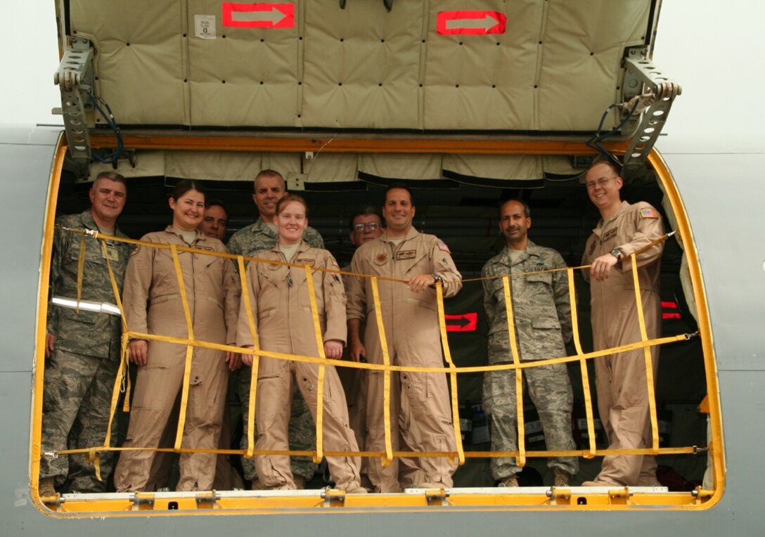 Nine members of the 108th Air Refueling Wing pose before they fly off for Ramstein, Germany on a 12-day deployment to assist with flights of injured service members.  From left to right are: Master Sgt. Steven Wescott, Tech Sgt. Samantha Gerofsky, Lt. Col. Martin Strittmatter, Master Sgt. Frank Dilberto, 1st Lt. Michelle WIlliams, Chief Master Sgt. John Connors, Lt. Col. Tony Devito, Master Sgt. Anthony Savino and Staff Sgt. Greg White.