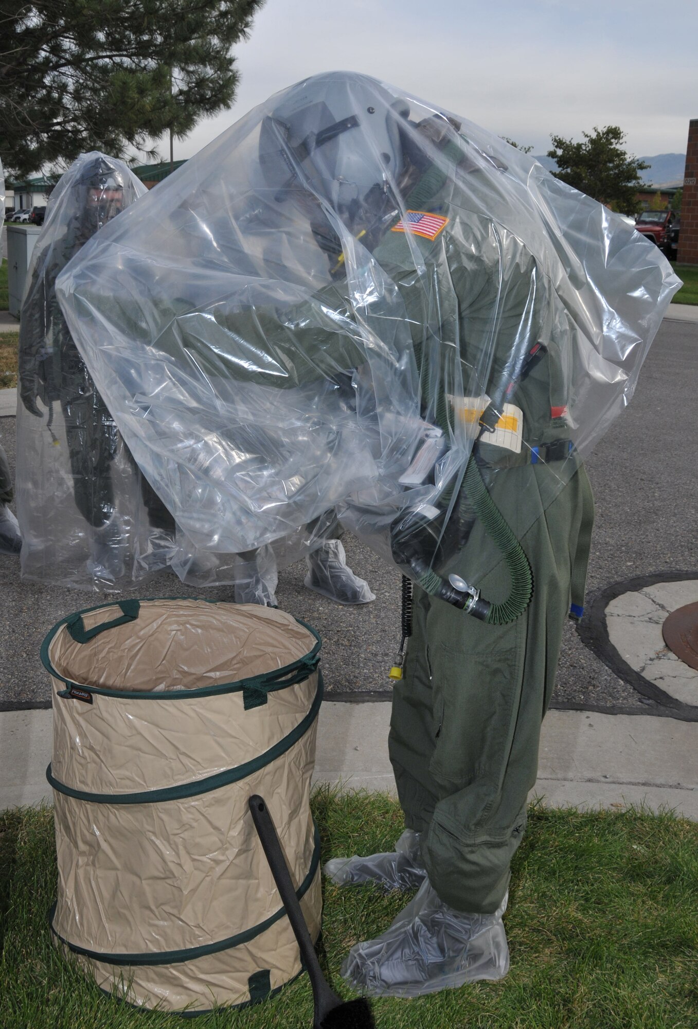 2nd Lt. Jason R Holbrook, 151st Operations Group, removes his chemical covering before moving to  a decontamination point during an Ability to Survive and Operate (ATSO) training exercise October 3. The exercise provided an opportunity for aircrew and support personnel to train in a simulated chemical environment. Air Force photo by Tech. Sgt. Michael D. Evans.
