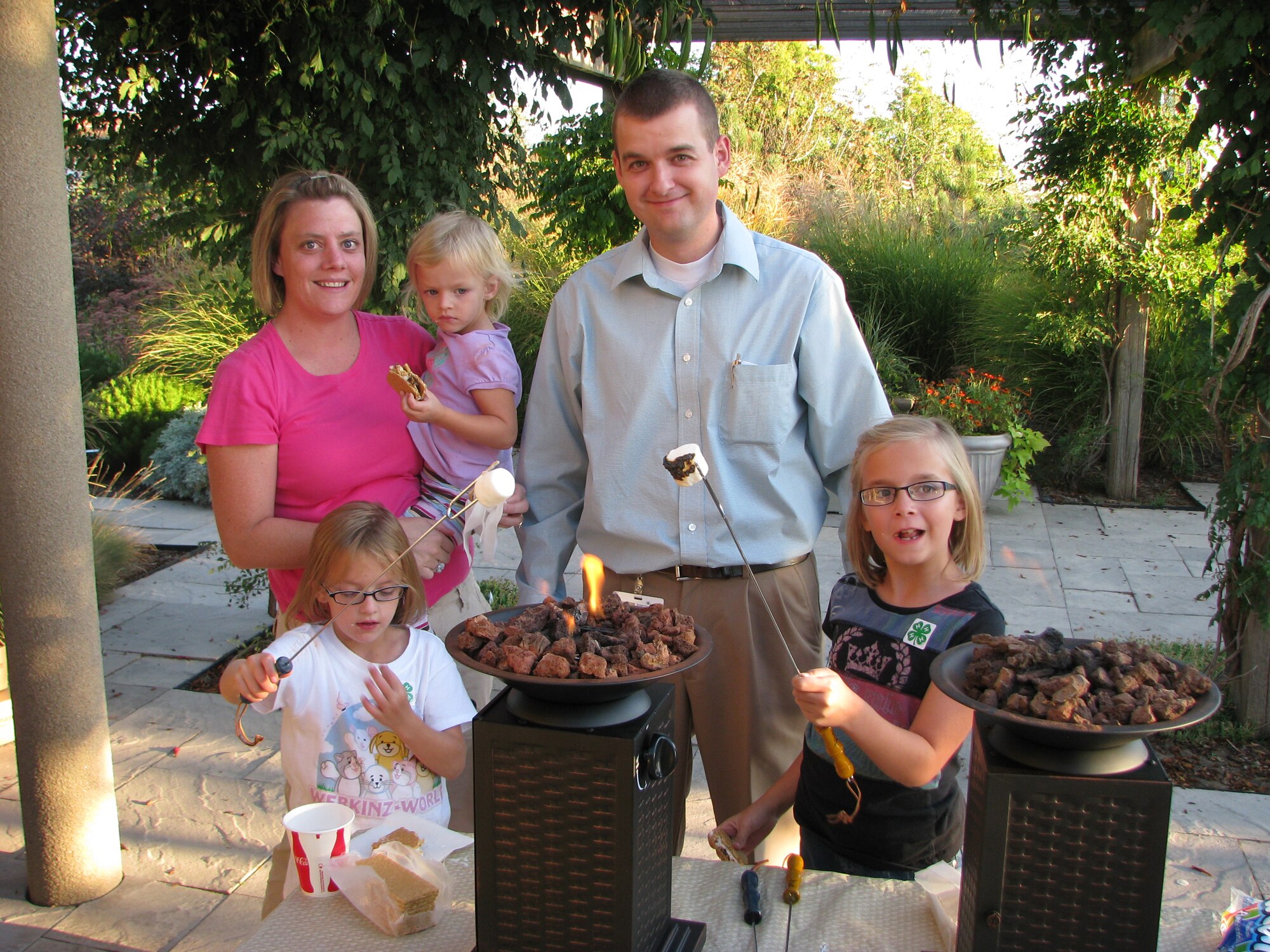KAYSVILLE, Utah  Utah Air National Guard's 1st Lt. Kevin Loveridge and wife Shikay roast s'mores at the Utah House during a recent Speak Out For Military Kids event in September.  Their daughters Kenedy, Gracie and Molly were able to participate in a variety of activities, from bird watching to generating electricity, during the military family event. Photo courtesy of Debbie Ramsay.