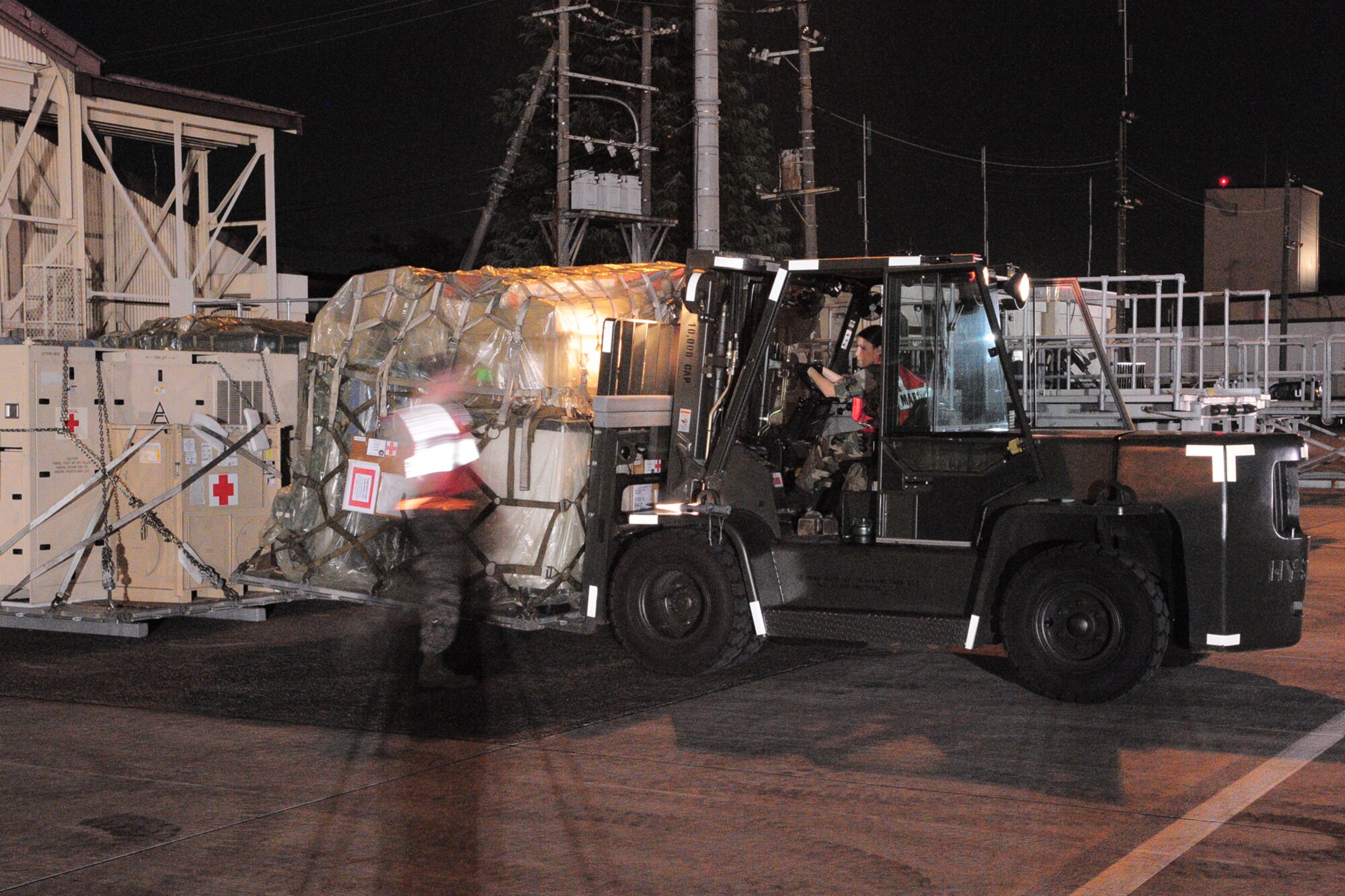 YOKOTA AIR BASE, Japan -- Senior Airman Leela Sutton, Logistics Readiness Squadron, moves a pallet Oct. 3 in support of the deployment of a U.S. Air Force Humanitarian Assistance Rapid Response Team to Padang, Indonesia. The HARRT, which includes members from here and Andersen Air Force Base, Guam, is scheduled to depart Oct. 5 aboard a C-17 Globemaster III. (U.S. Air Force photo/Airman 1st Class Michael Dillon)