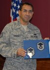 Newly promoted Master Sgt. Oswaldo Roman, 919th Maintenance Squadron, shows off his new stripes after Col. Jon Weeks, 919th Special Operations Wing commander, and Chief Master Sgt. Michael Klausutis, wing command chief, informed him he was out of uniform.  Sergeant Roman was promoted Oct. 3 via the Air Force Reserve’s Promotion Enhancement Program.  (U.S. Air Force photo/Staff Sgt. Samuel King Jr.)