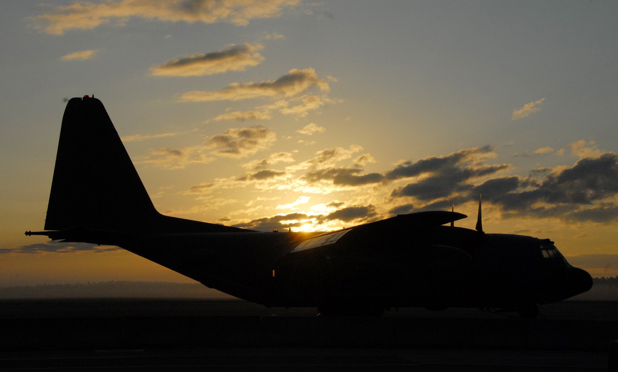 The sun peaks over the clouds and the wings of a 919th Special Operations Wing MC-130E Combat Talon I Oct. 3 morning at Duke Field, Fla.  The sun brought light to the first UTA weekend in the new fiscal year for the Reserve unit.  (U.S. Air Force photo/Staff Sgt. Samuel King Jr.) 
