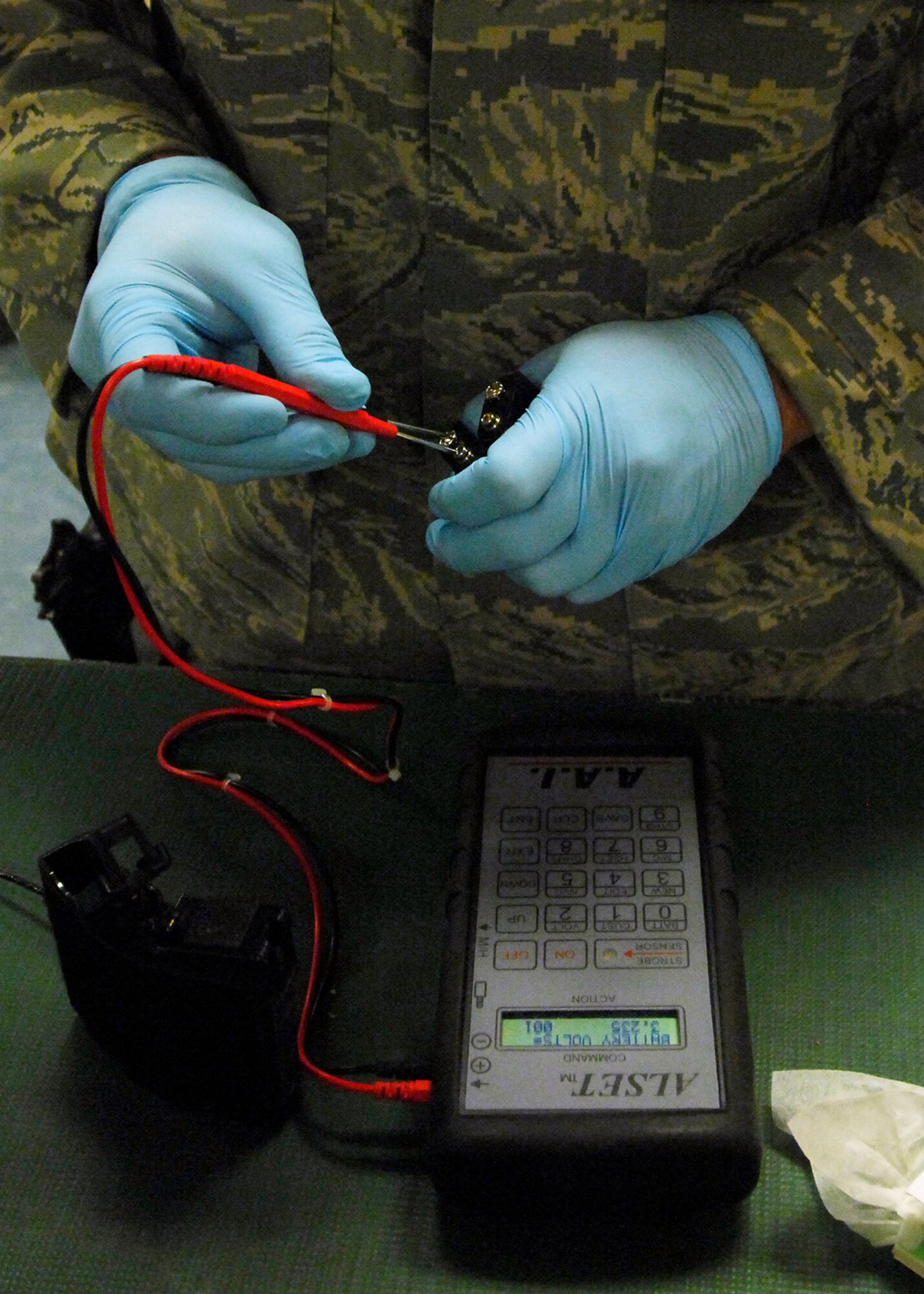 BAGRAM AIRFIELD, Afghanistan -- Senior Airman Eduardo Teixeira, an Aircrew Flight Equipment Airman from the 774th Expeditionary Airlift Squadron, tests the batteries of the night vision goggles here, Oct. 4, 2009.  Inspections and cleaning are done after every use to ensure the pilot and crews safety.  Airman Teixeira, a Recise, Brazil native, is deployed from the California Air National Guard's 115th Airlift Squadron.  (U.S. Air Force photo/Senior Airman Felicia Juenke)